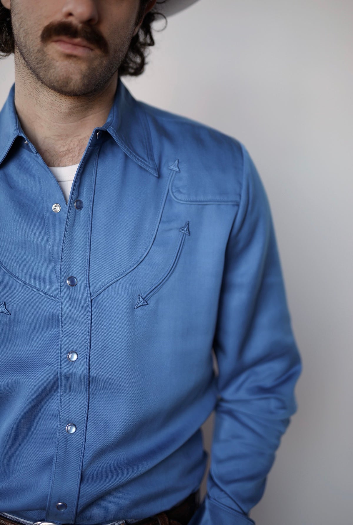 Front close-up of the H Bar C Reno royal blue shirt with piped yoke and pearl snaps.