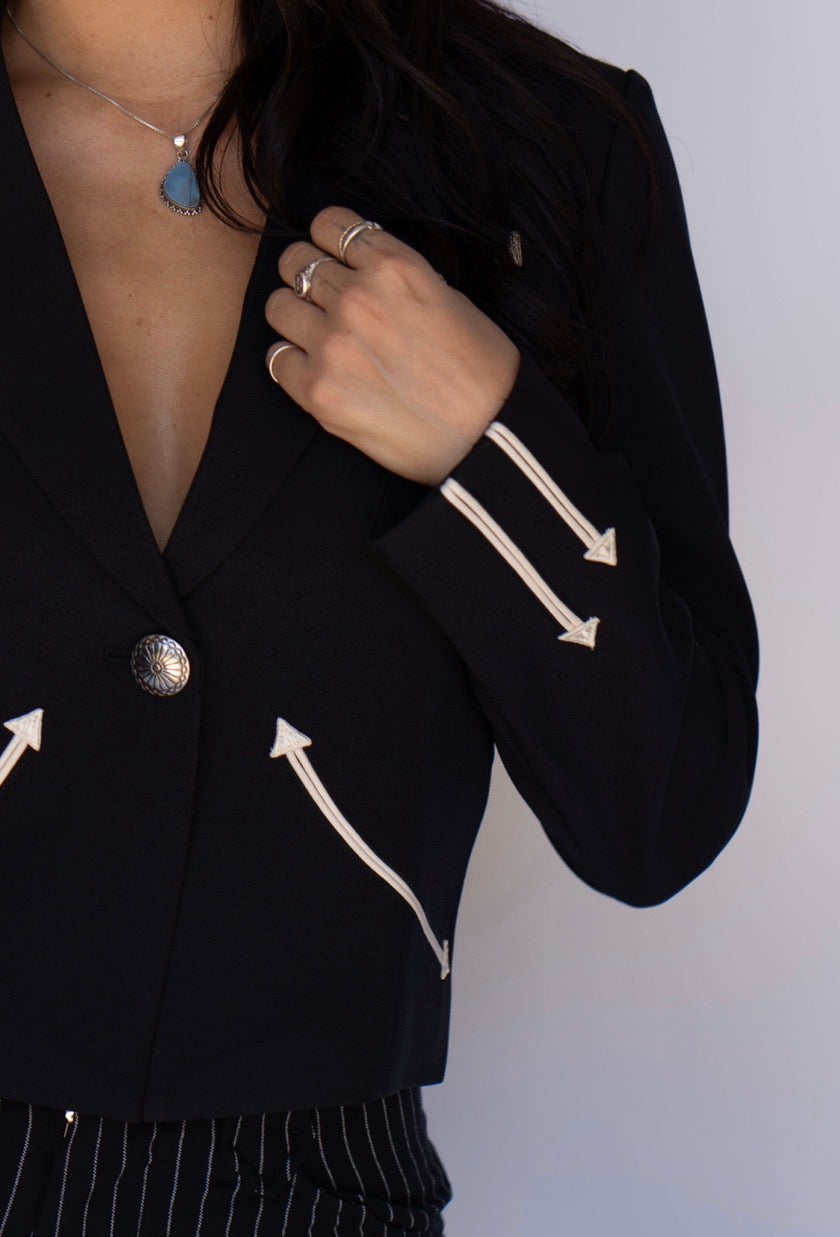 Detail of the embroidered cream arrows on the sleeve and front of the H Bar C Calamity women's black blazer.