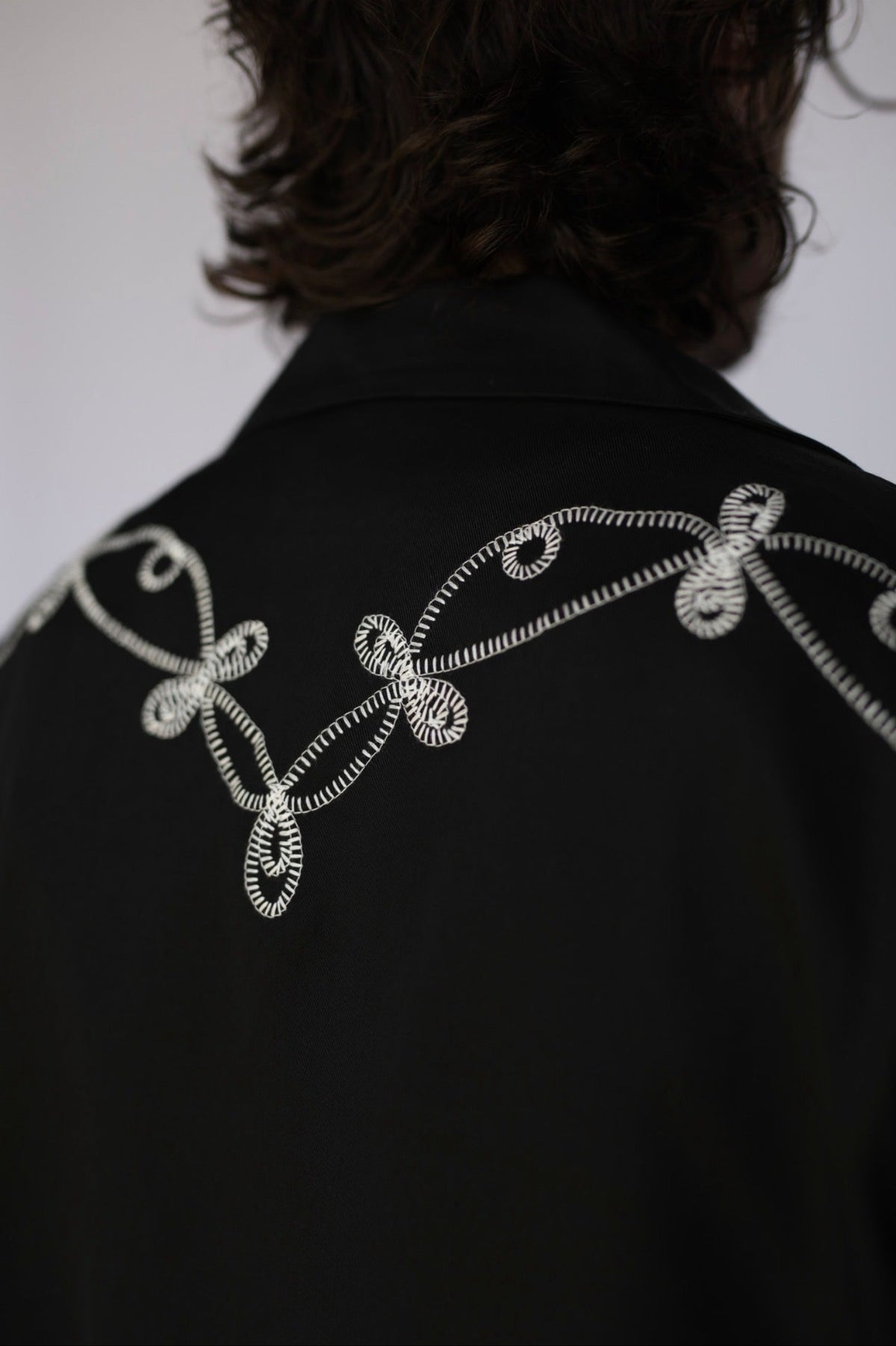 Close-up of the back shoulder embroidery on the H Bar C Bolero El Patrón black and white jacket.