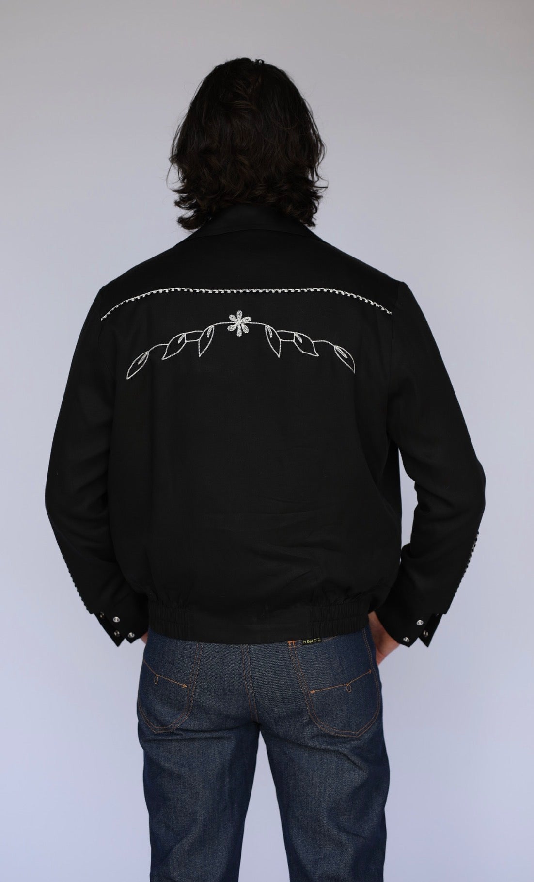Back view of the H Bar C Bolero Nogales men's black and white hip-length western jacket.