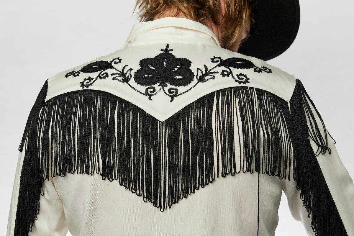 Back yoke of the H Bar C Taos white shirt with black embroidery and fringe.