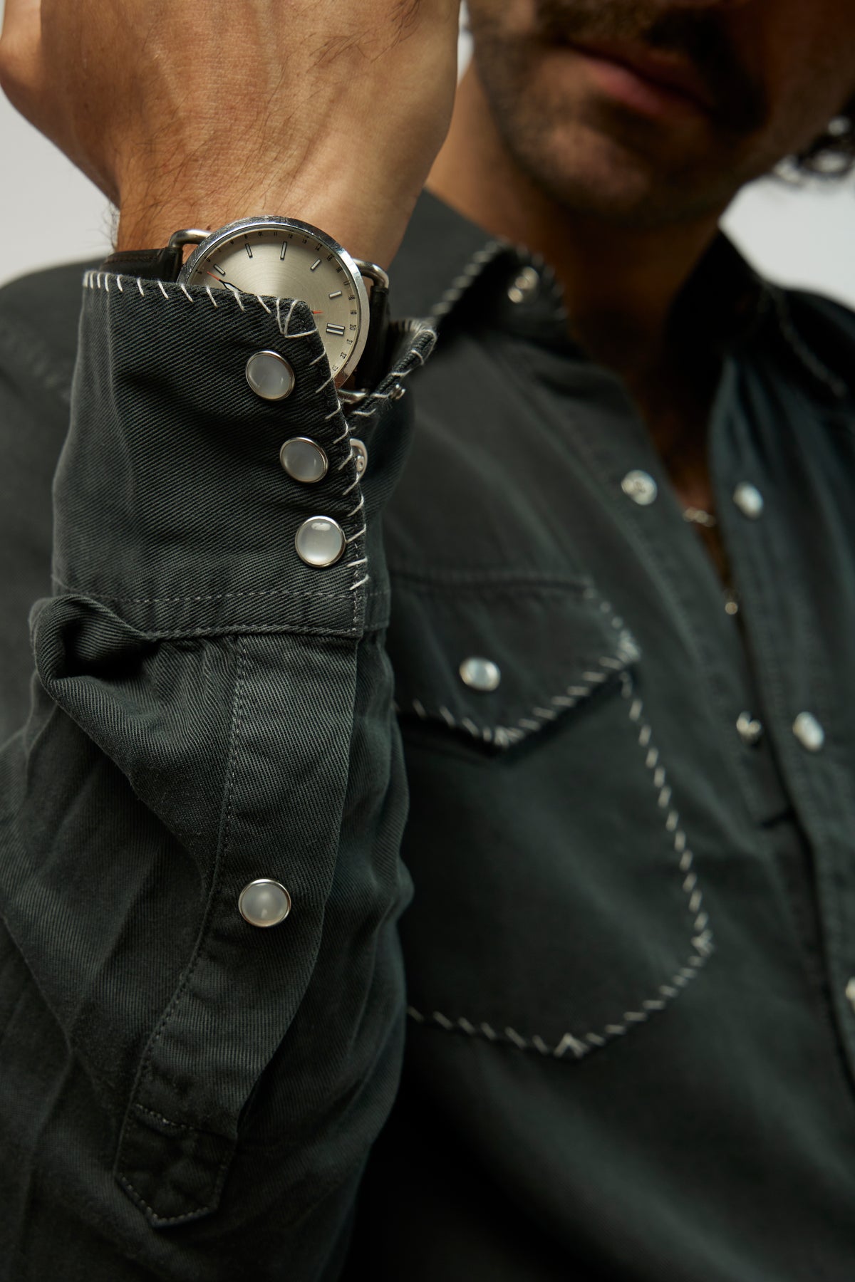 Cuff and pocket detail of the H Bar C Brooklyn black western shirt with snap buttons and contrast stitching.