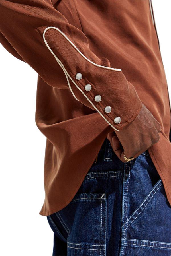 Rodeo cuff detail of the H Bar C San Juan brown shirt with pearl snaps and piping.