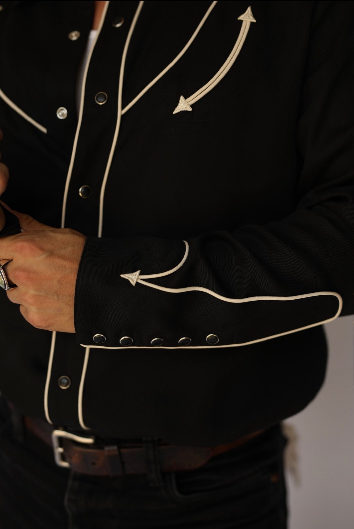 Close-up of the piped multi-snap cuff on the H Bar C Reno black and off-white shirt.