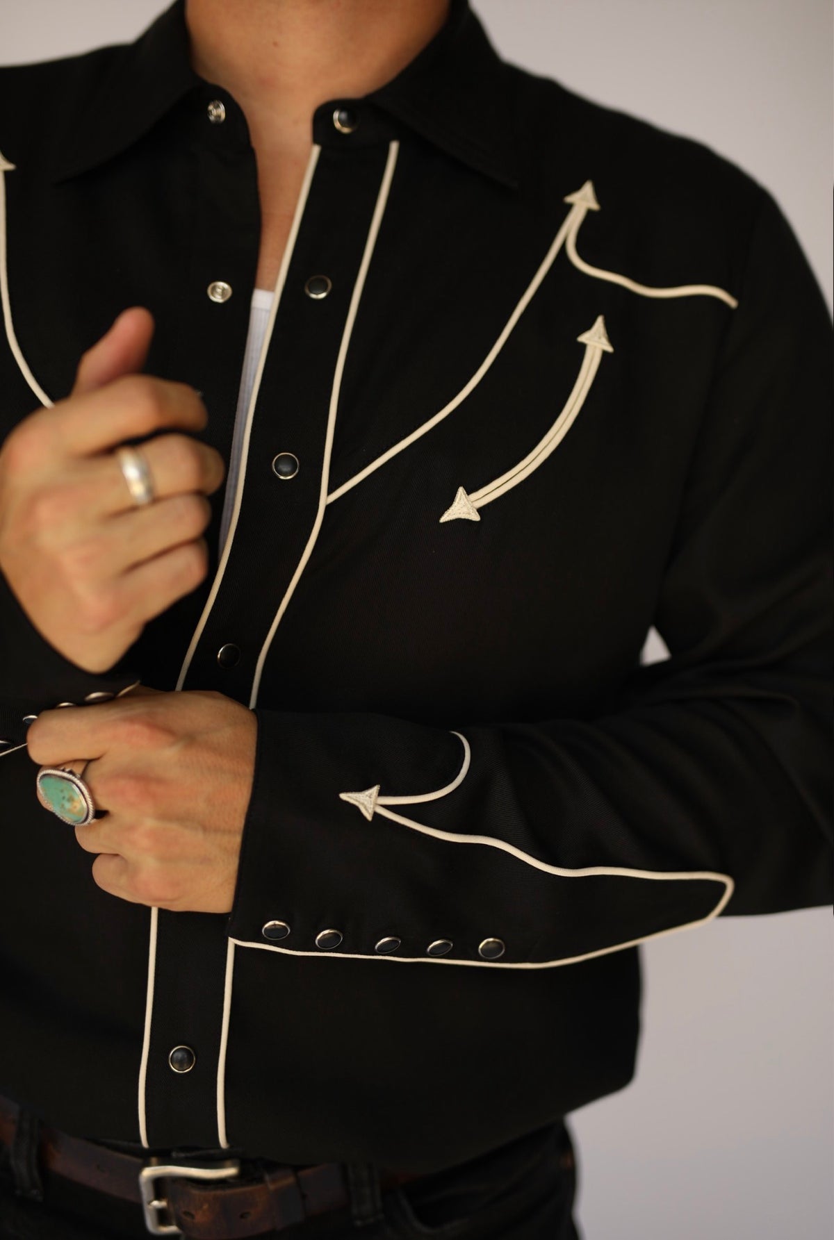 Detail of the off-white arrow piping and snap placket on the H Bar C Reno black western shirt.