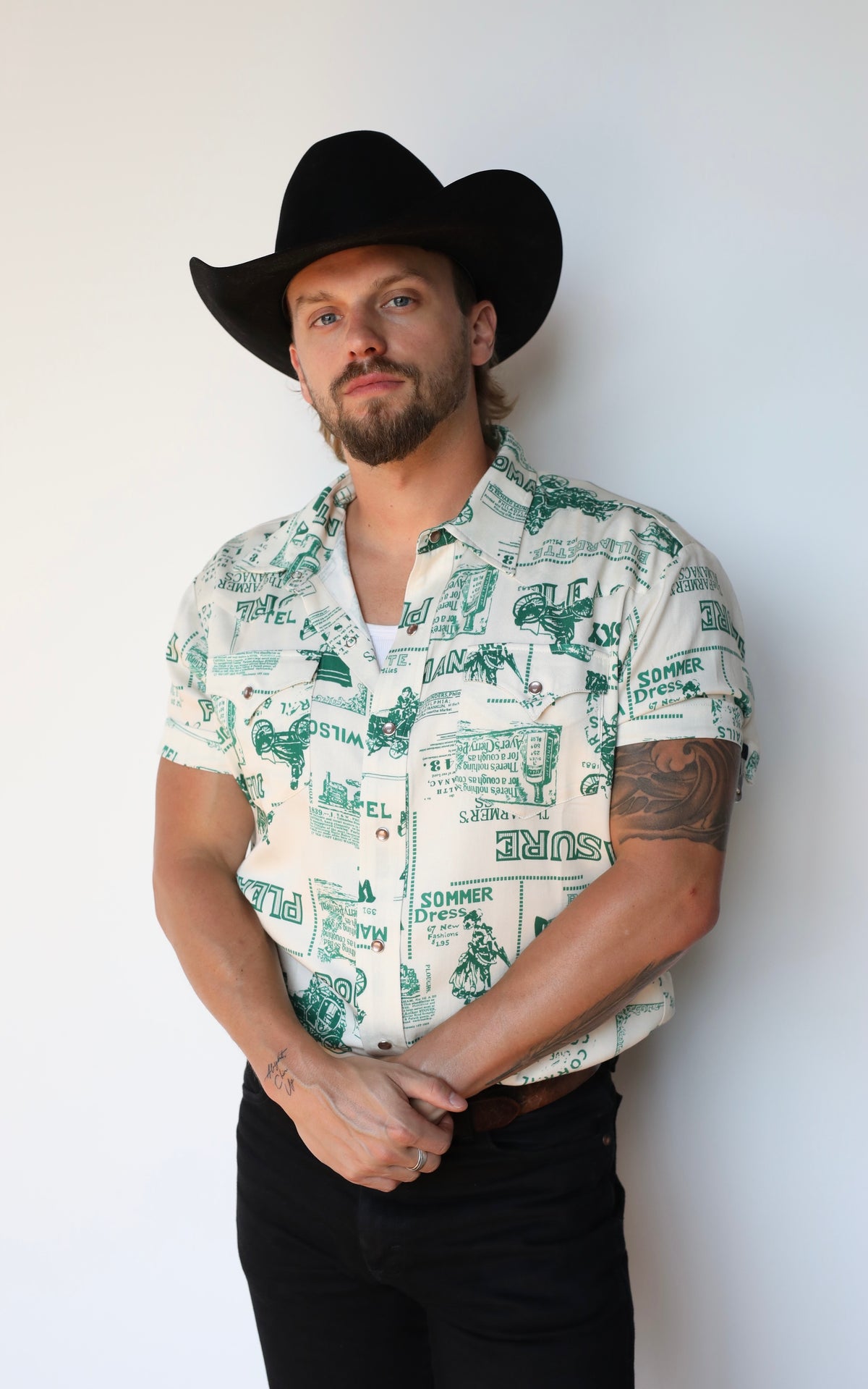 Man wearing the H Bar C Newport Somerville printed western shirt with black jeans.