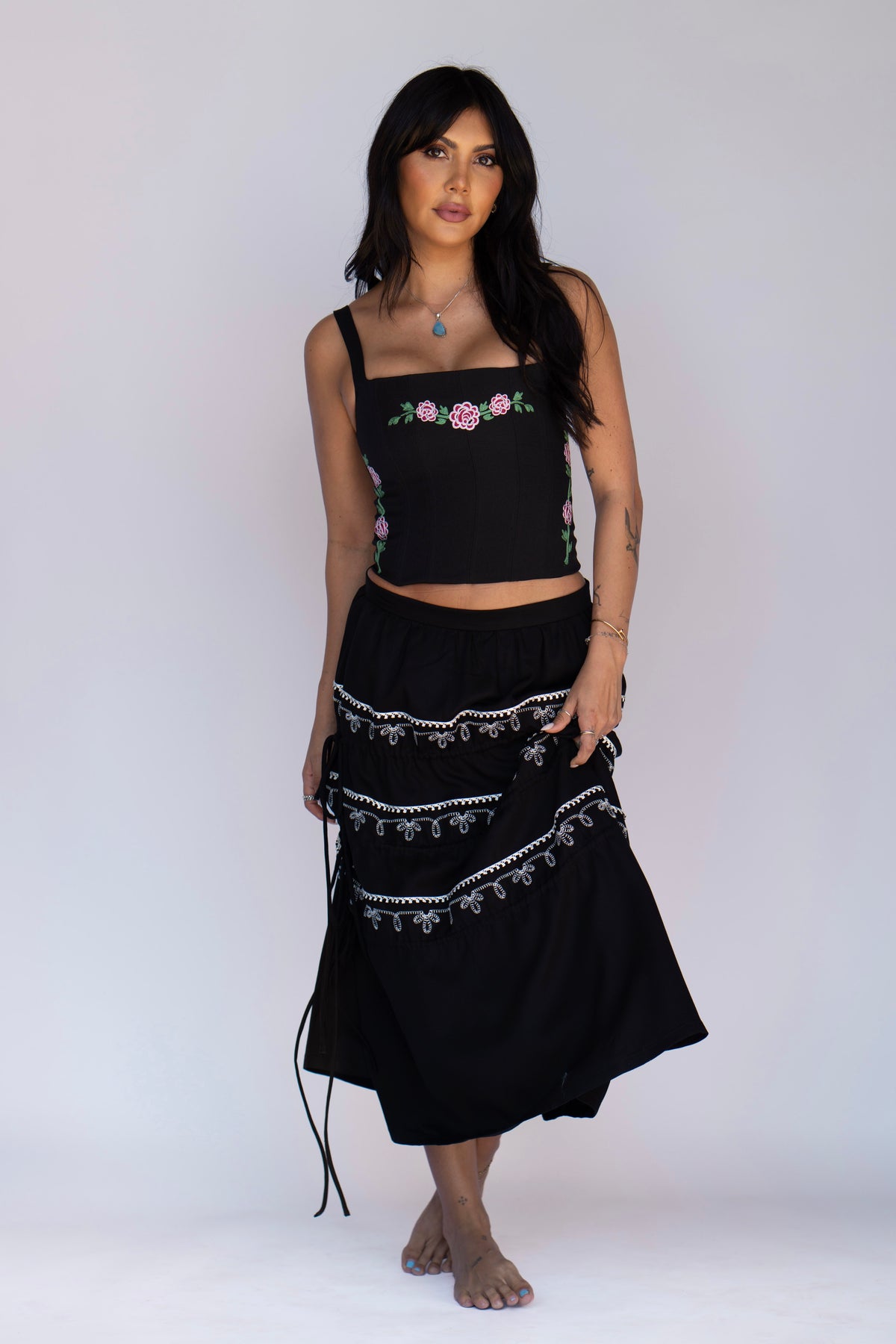 Model in the H Bar C Coachella tiered black skirt with drawstring ties and the black Canterbury corset.