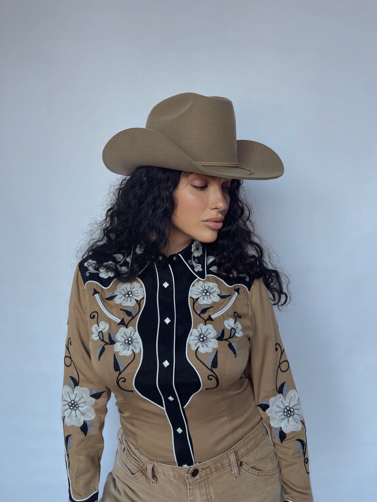 Front view of the H Bar C Santa Ana tan and black embroidered western shirt with tan pants.
