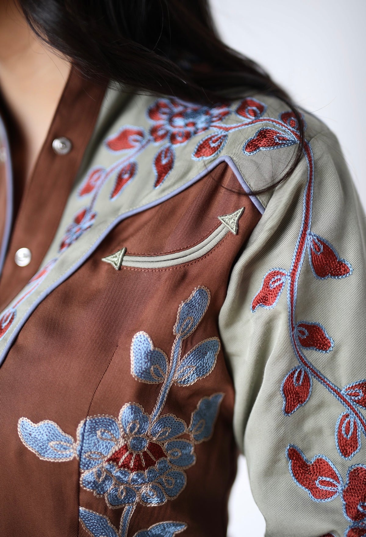 Sleeve detail of the red and blue floral embroidery on the H Bar C San Antonio women's brown shirt.