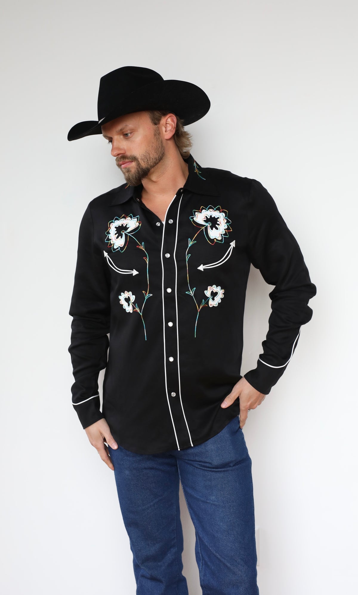 Three-quarter view of the H Bar C Texas men's black shirt with floral embroidery and pearl snaps.