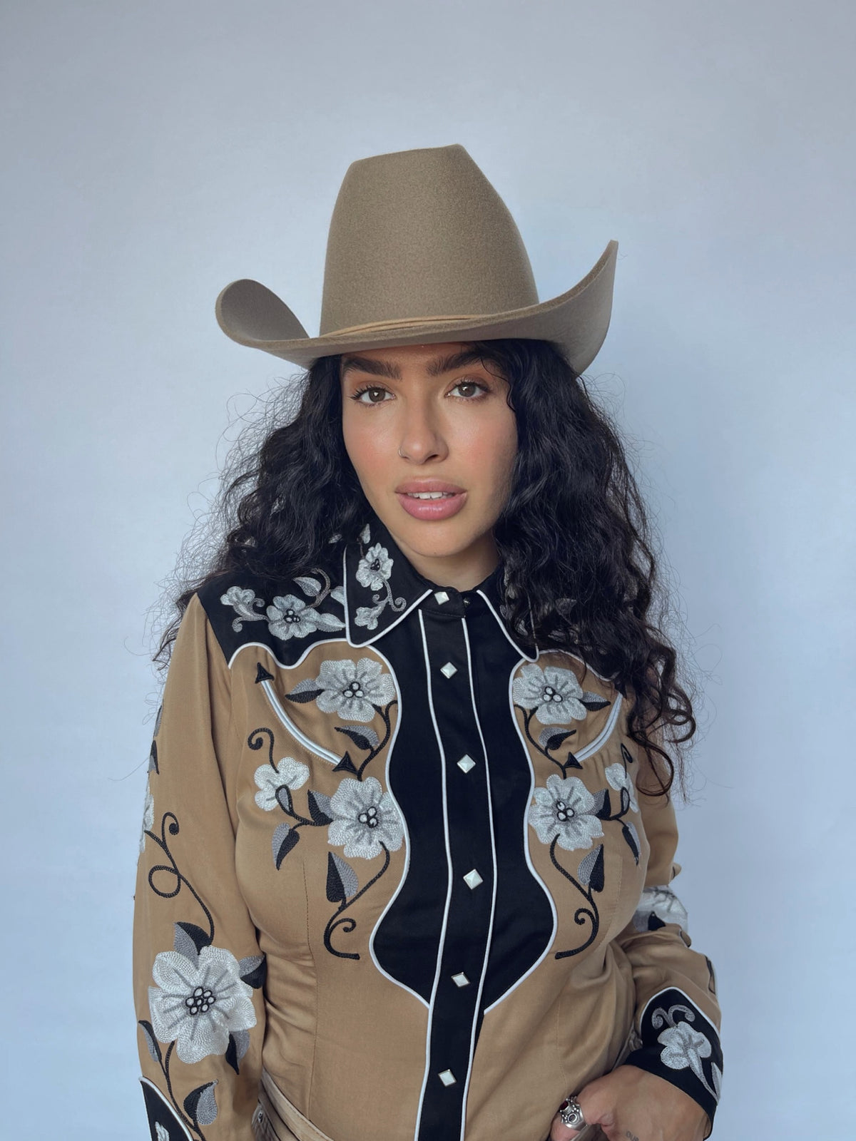 Model in the H Bar C Santa Ana tan western shirt with black floral yokes and a cowboy hat.