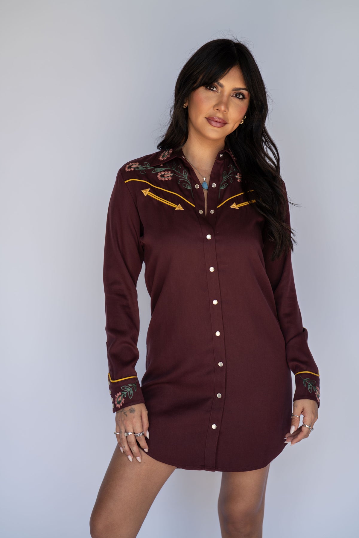 Woman wearing the H Bar C Sedona maroon embroidered western dress, inspired by an archive H Bar C women's shirt.