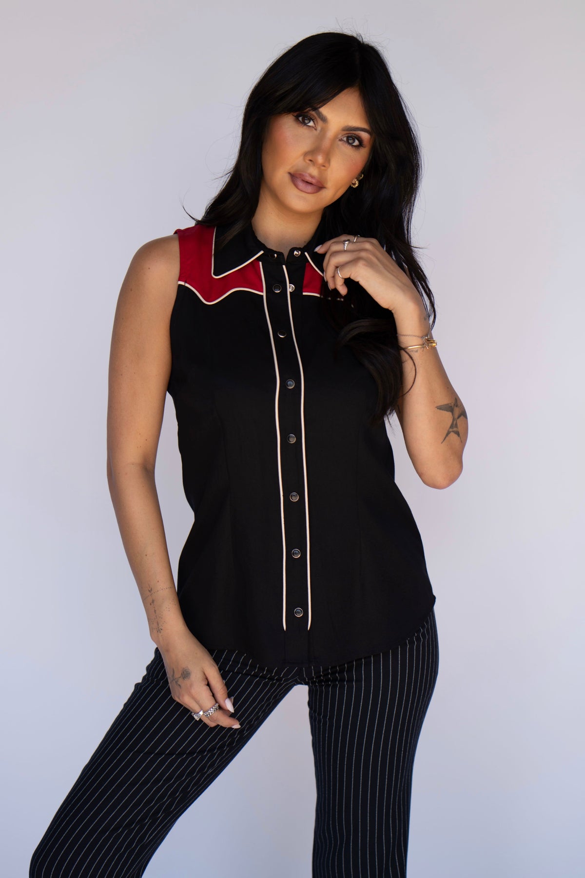 Full length view of the H Bar C Atlanta women's black and red sleeveless shirt with pinstripe pants.