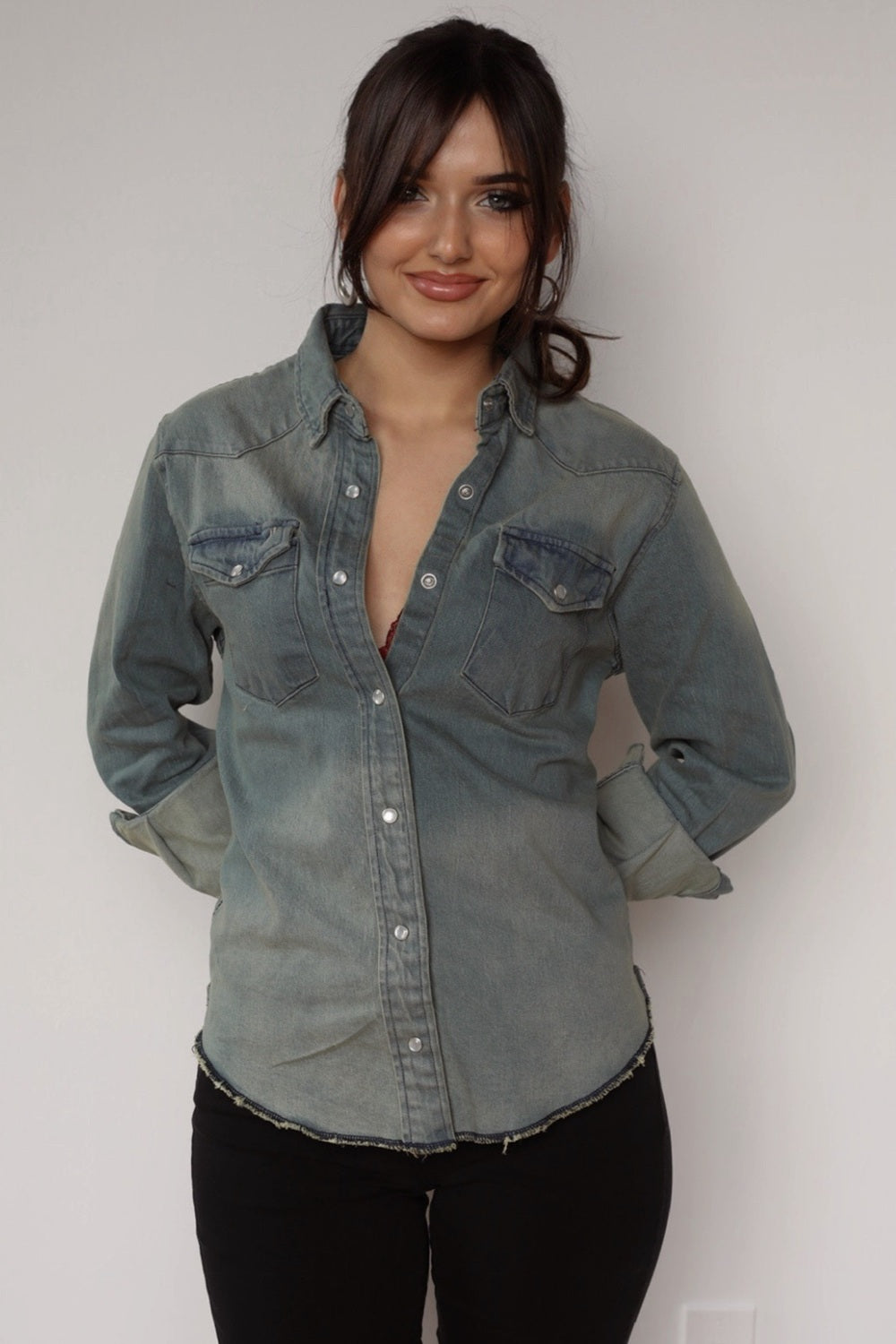 Woman wearing the H Bar C Resurgent women's shirt, a stonewashed denim pearl snap western shirt.