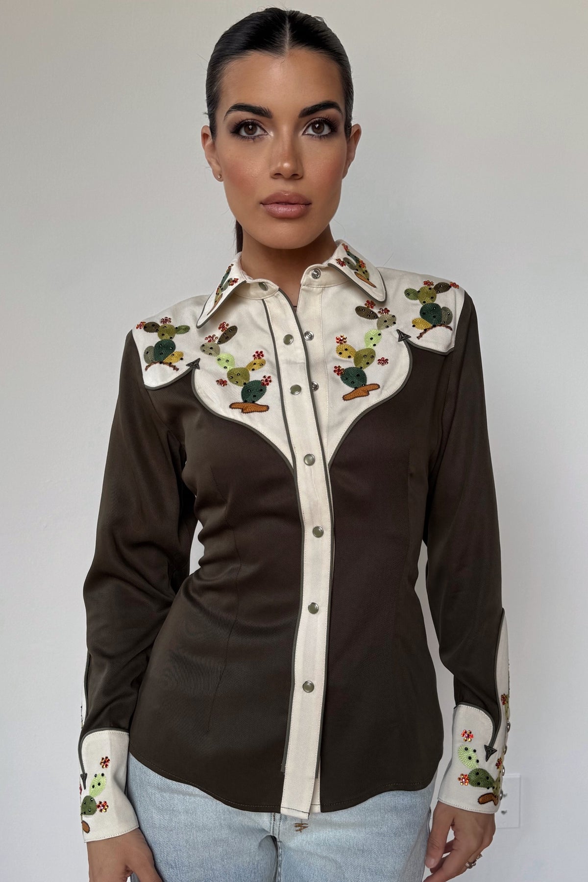 Woman wearing the H Bar C San Jose women's shirt in dark green with cream yokes and cactus embroidery.