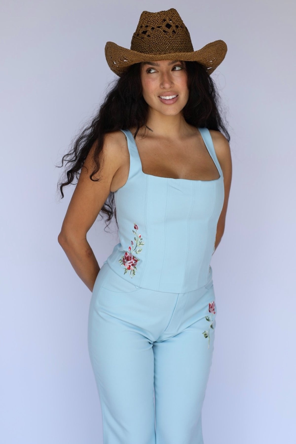 Full length view of the H Bar C Abilene blue corset and pants set with a straw cowboy hat.