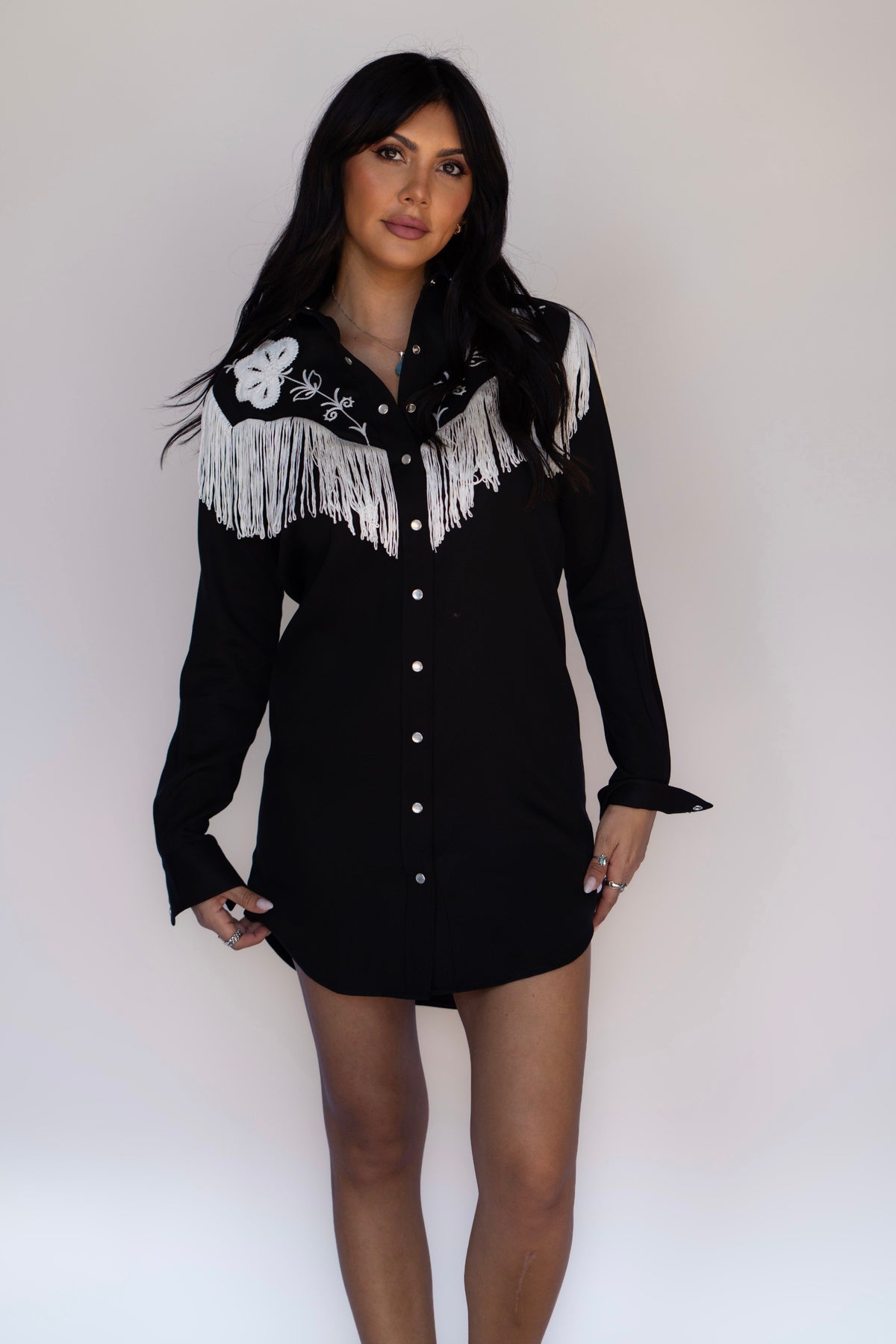 Woman posing in the H Bar C Roswell black long sleeve fringe shirt dress.