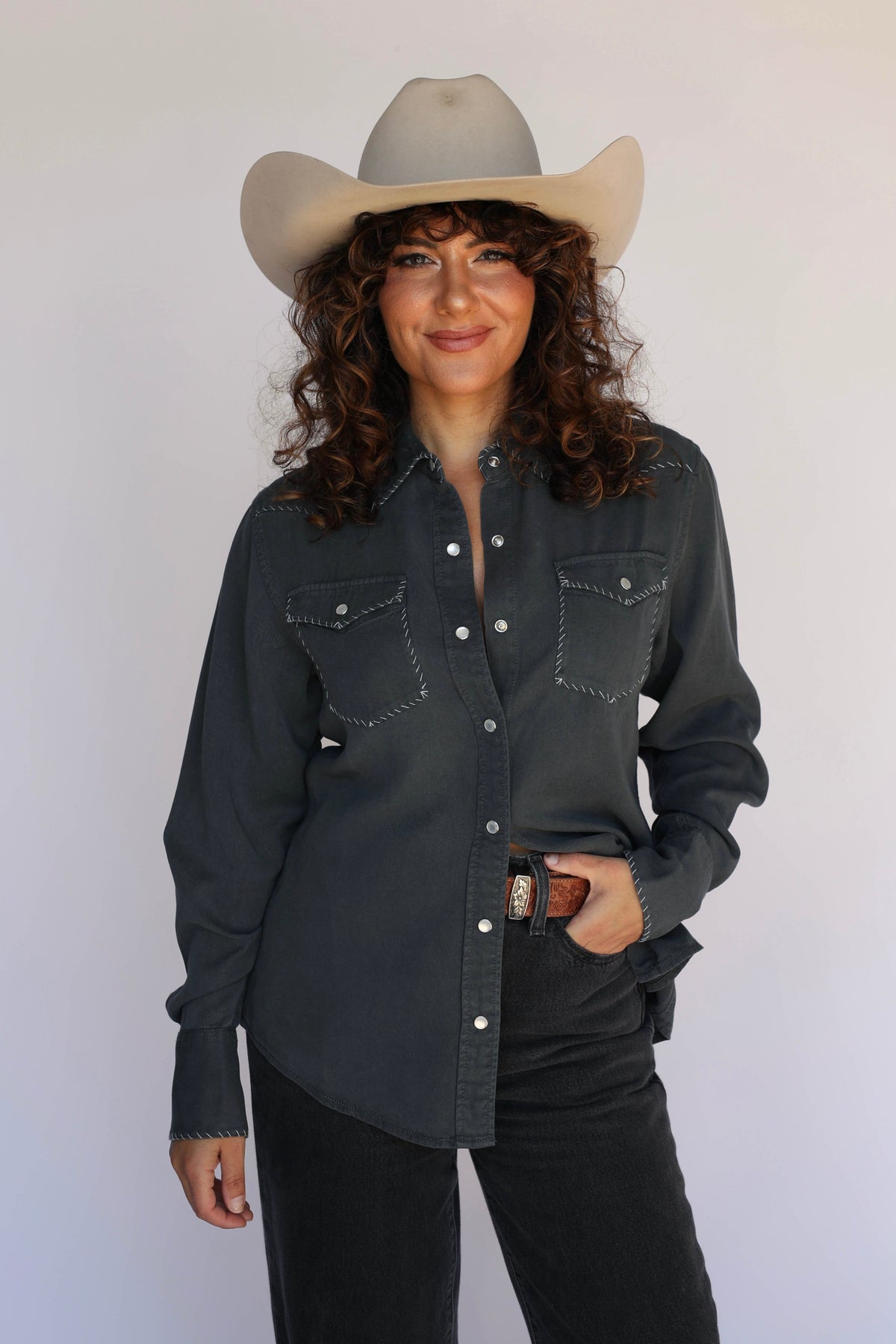 Woman with hand in pocket in the H Bar C Brooklyn charcoal slate western shirt and cowboy hat.