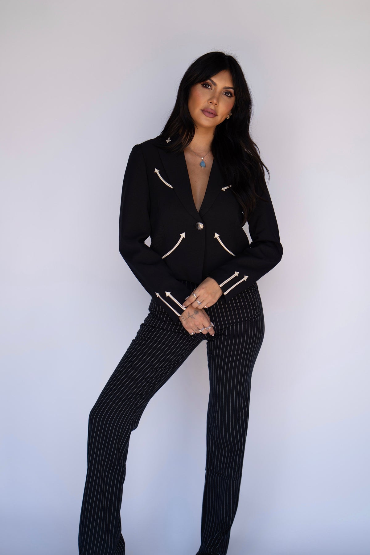 Full length view of the H Bar C Calamity women's black jacket styled with black pinstripe pants.