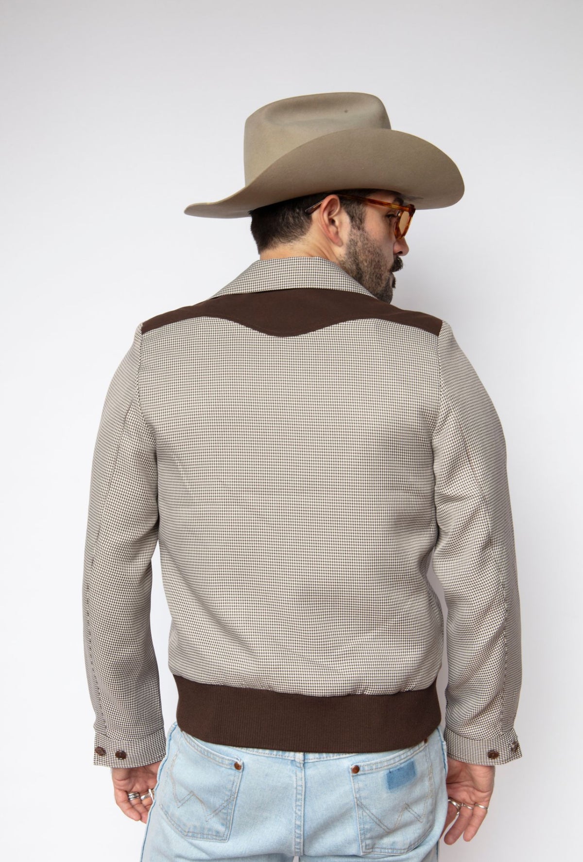 Back view of the H Bar C Kentucky espresso houndstooth jacket with suede back yoke and ribbed hem.