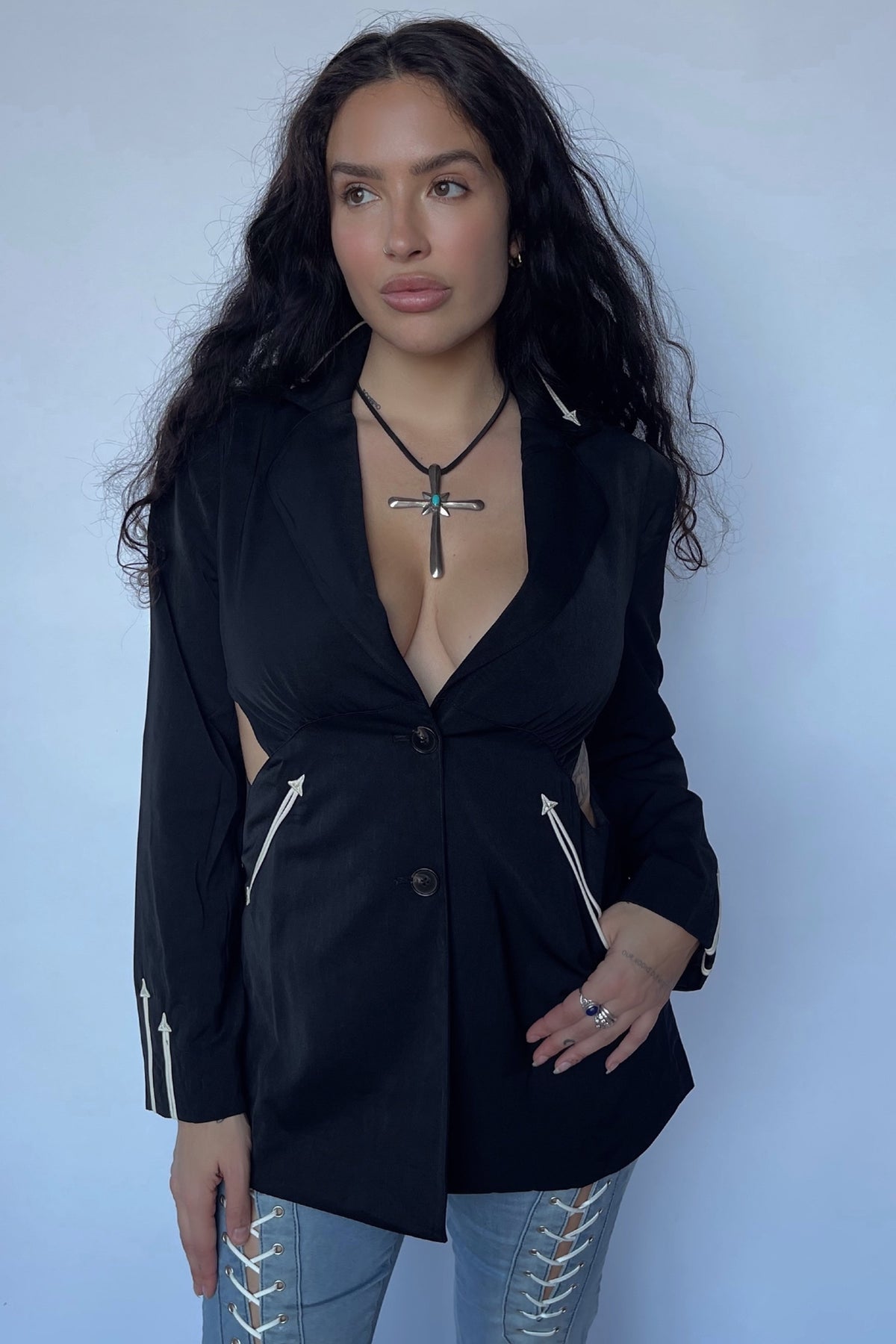 Woman wearing the H Bar C Phoenix women's jacket in black with white arrow trim, a deep V take on the Calamity.