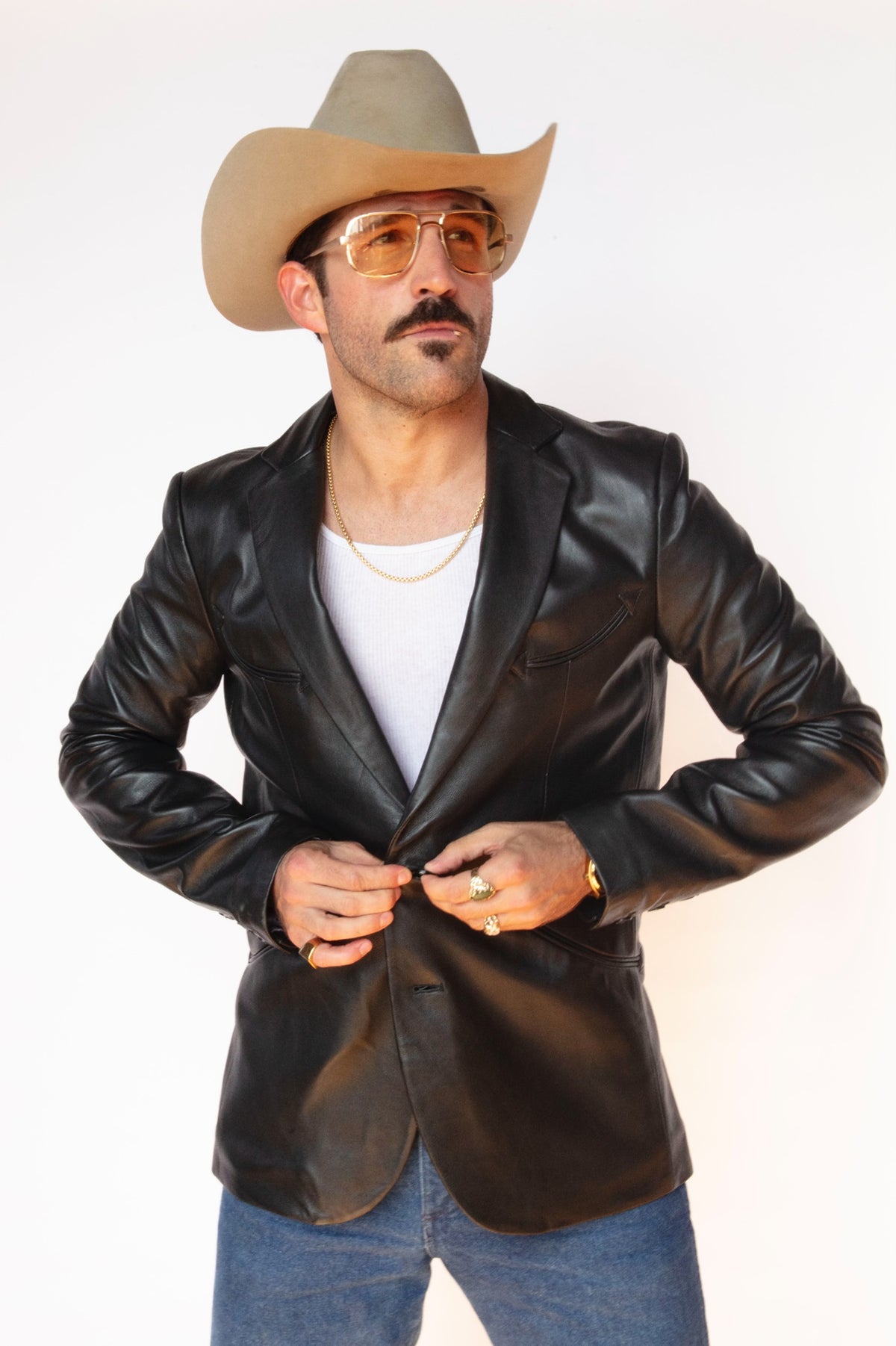 Man in a cowboy hat wearing the H Bar C Carson men's jacket, a black lambskin rock and roll western blazer designed by Jess Carson.