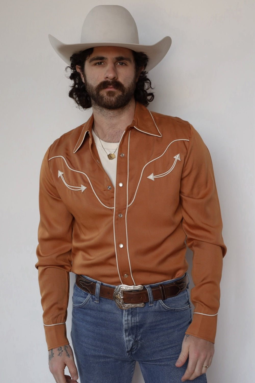 Front view of the H Bar C San Fernando burnt orange western shirt with cream piping, worn with jeans and a cream cowboy hat.