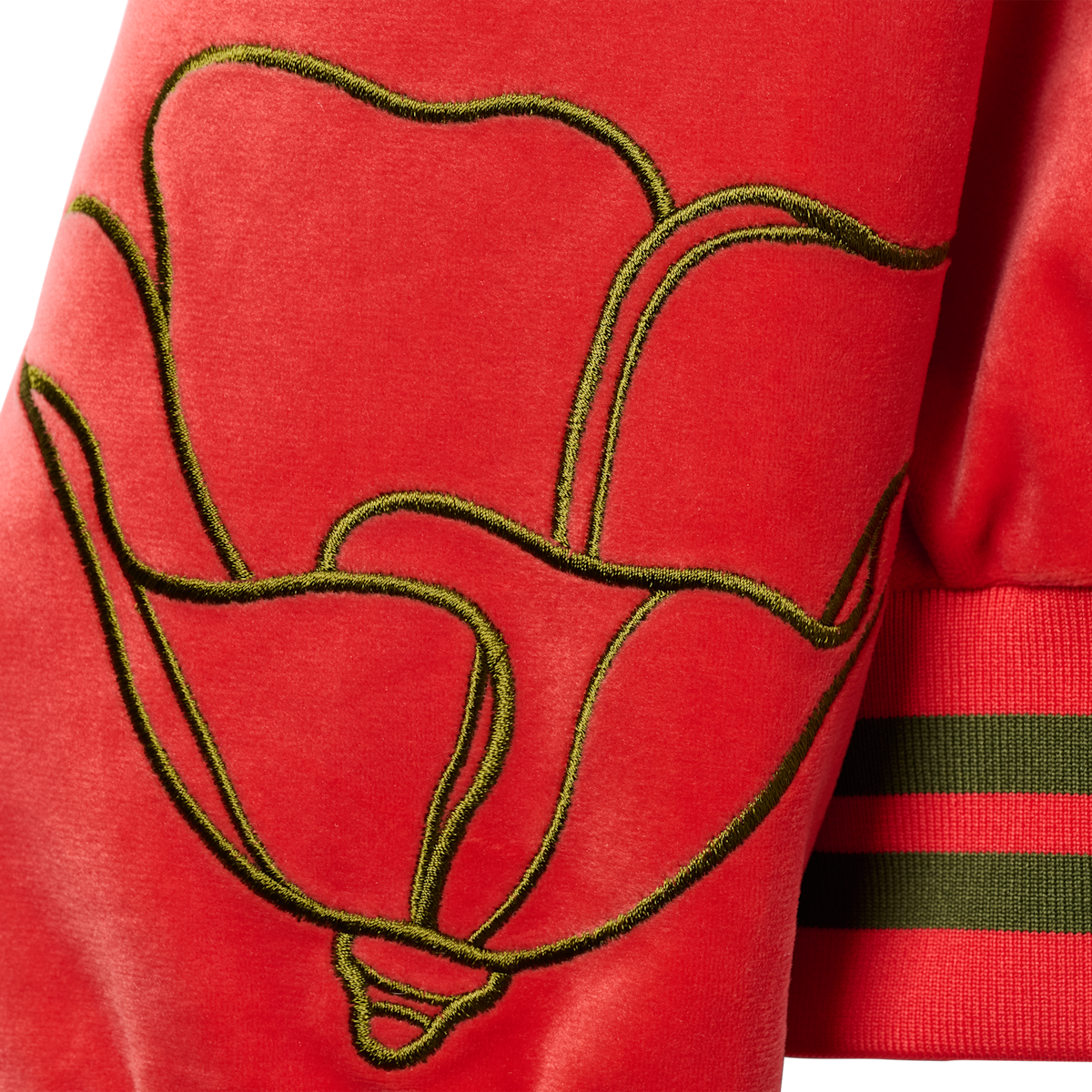 Sleeve detail of the embroidered poppy outline and striped cuff on the HBarC x Gibson Dove tour jacket.