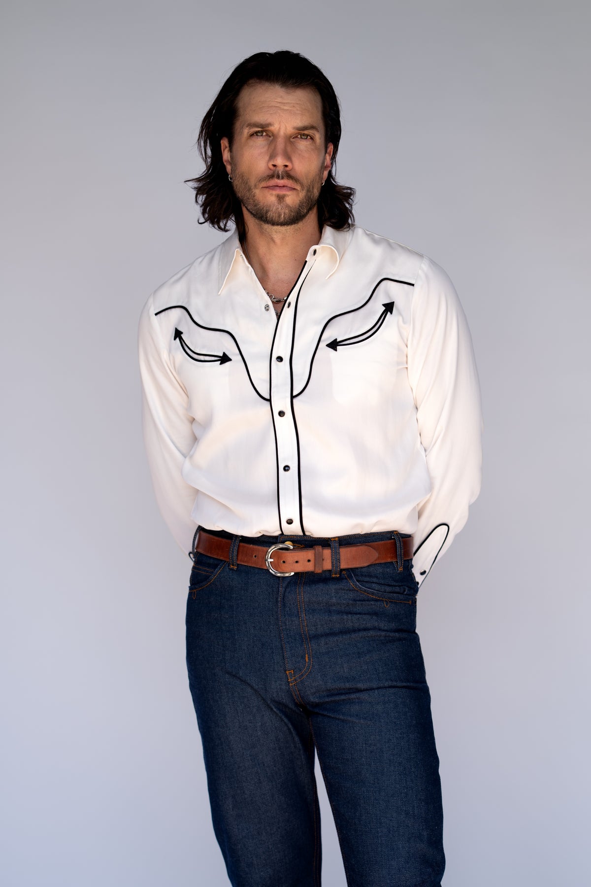 Front view of the H Bar C San Fernando men's white western shirt tucked into dark jeans.
