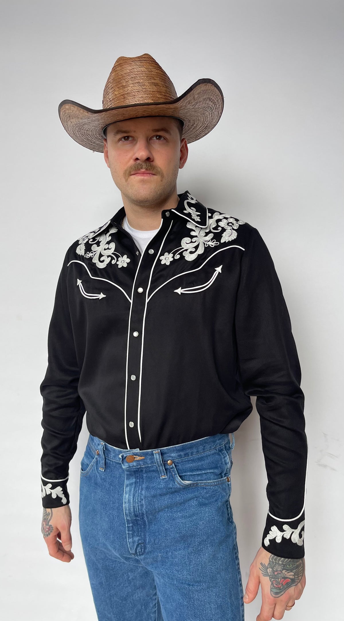 Front view of the H Bar C Durango black embroidered western shirt with jeans.