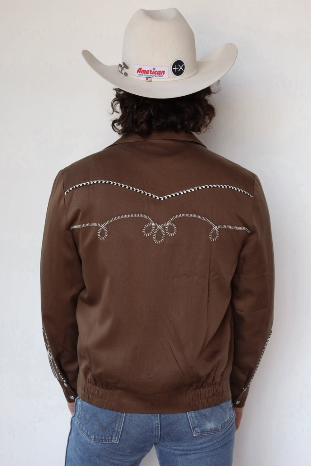 Back view of the H Bar C Bolero walnut and white jacket with white chain stitch embroidery across the back yoke.