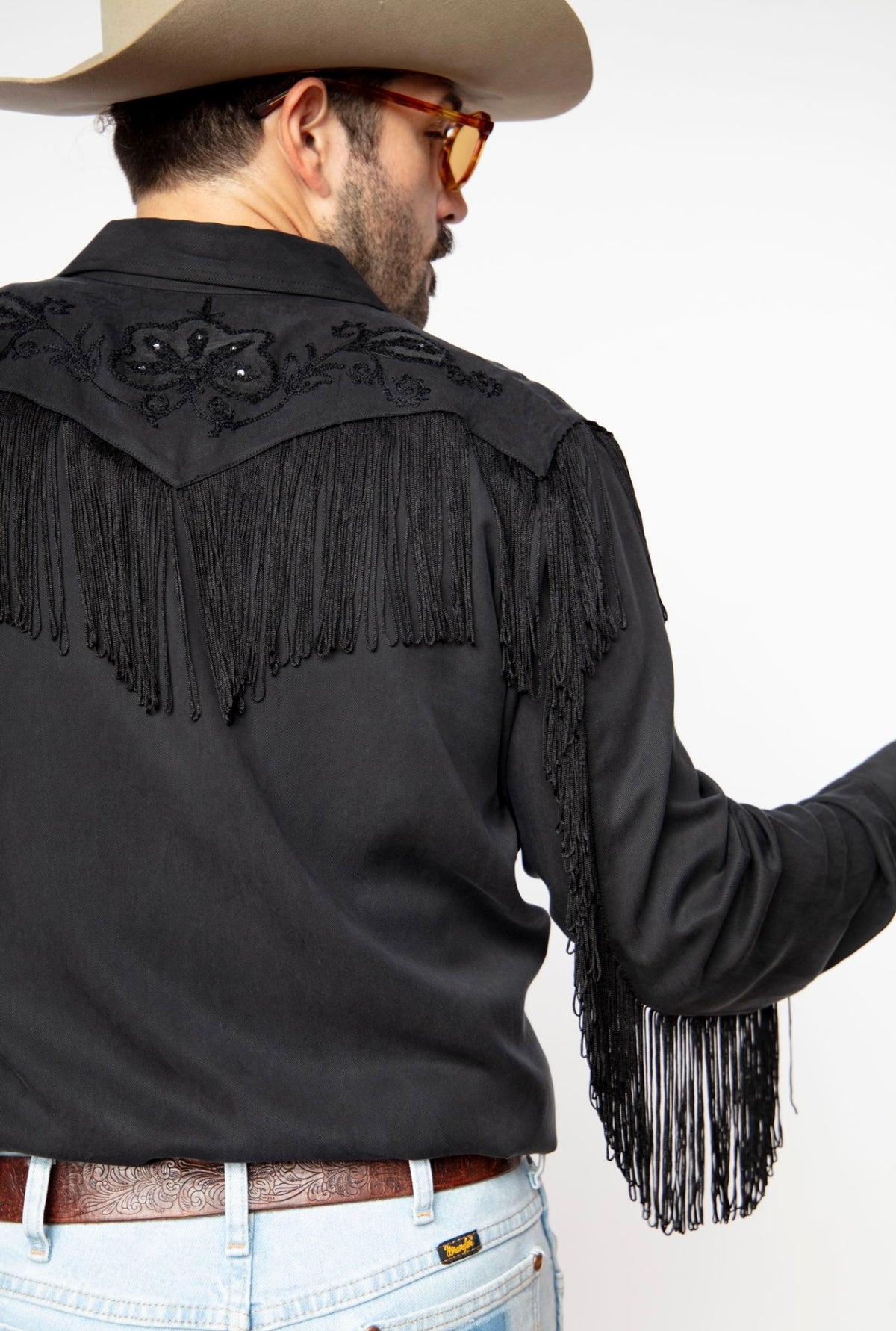 Back shoulder view of the H Bar C Taos black shirt with black fringe across the yoke and sleeves.
