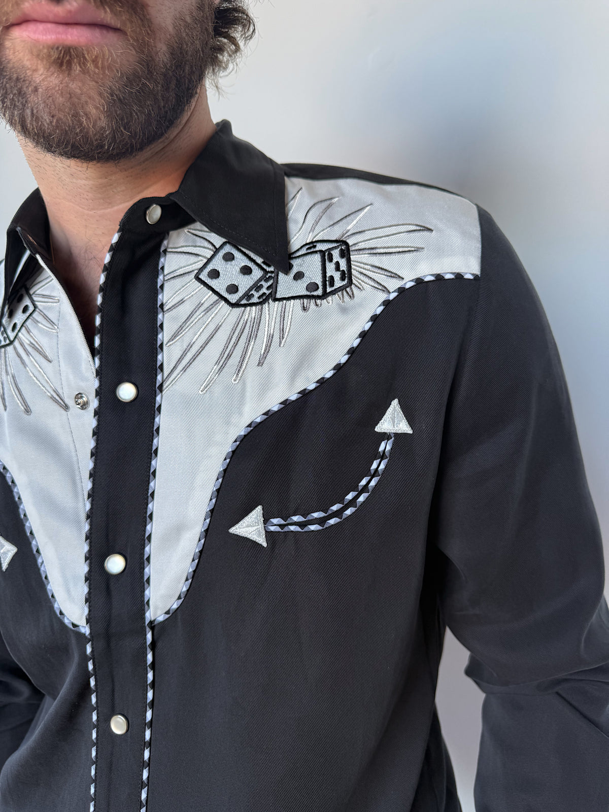 Close-up of the white embroidered yoke and arrow detail on the H Bar C Jillette black shirt.