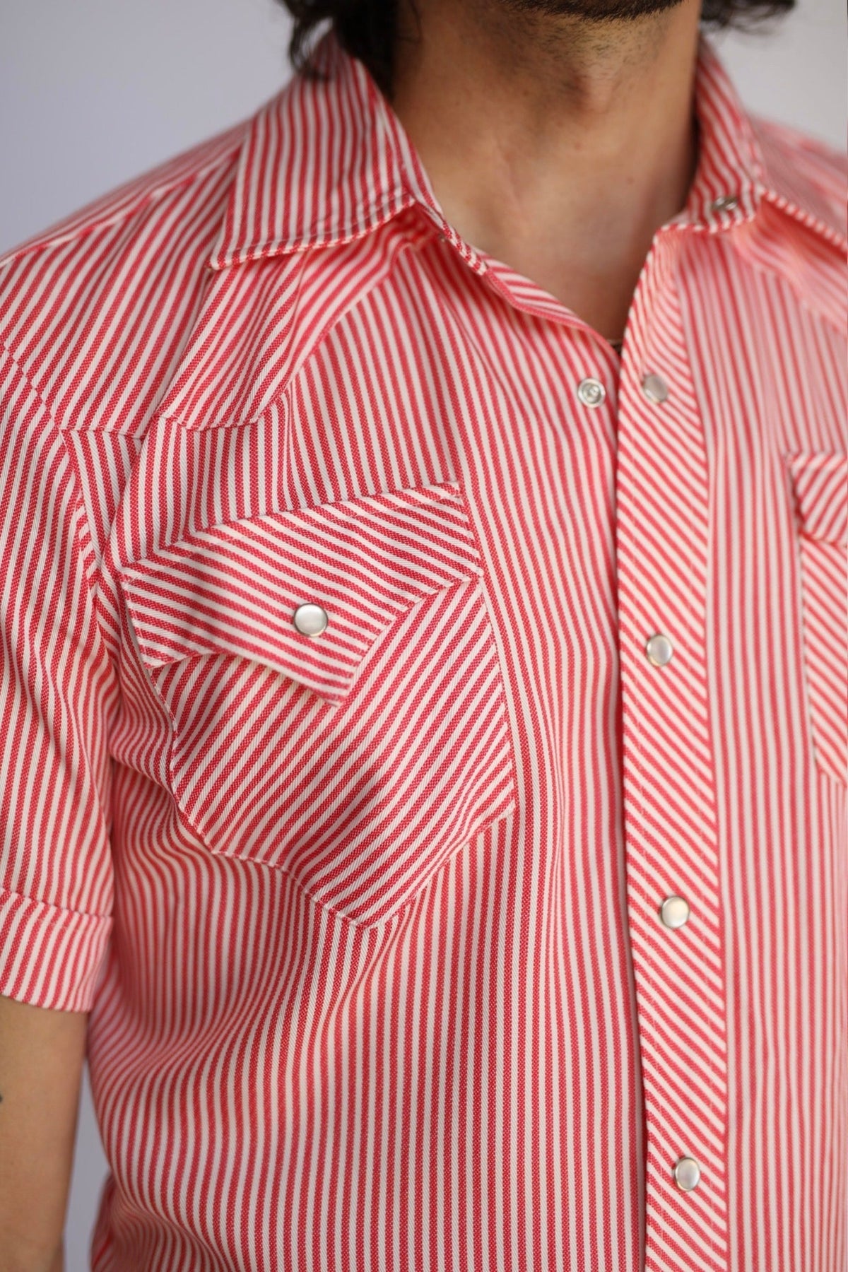 Close-up of the red and white stripe pocket and snap on the H Bar C Newport red striped shirt.