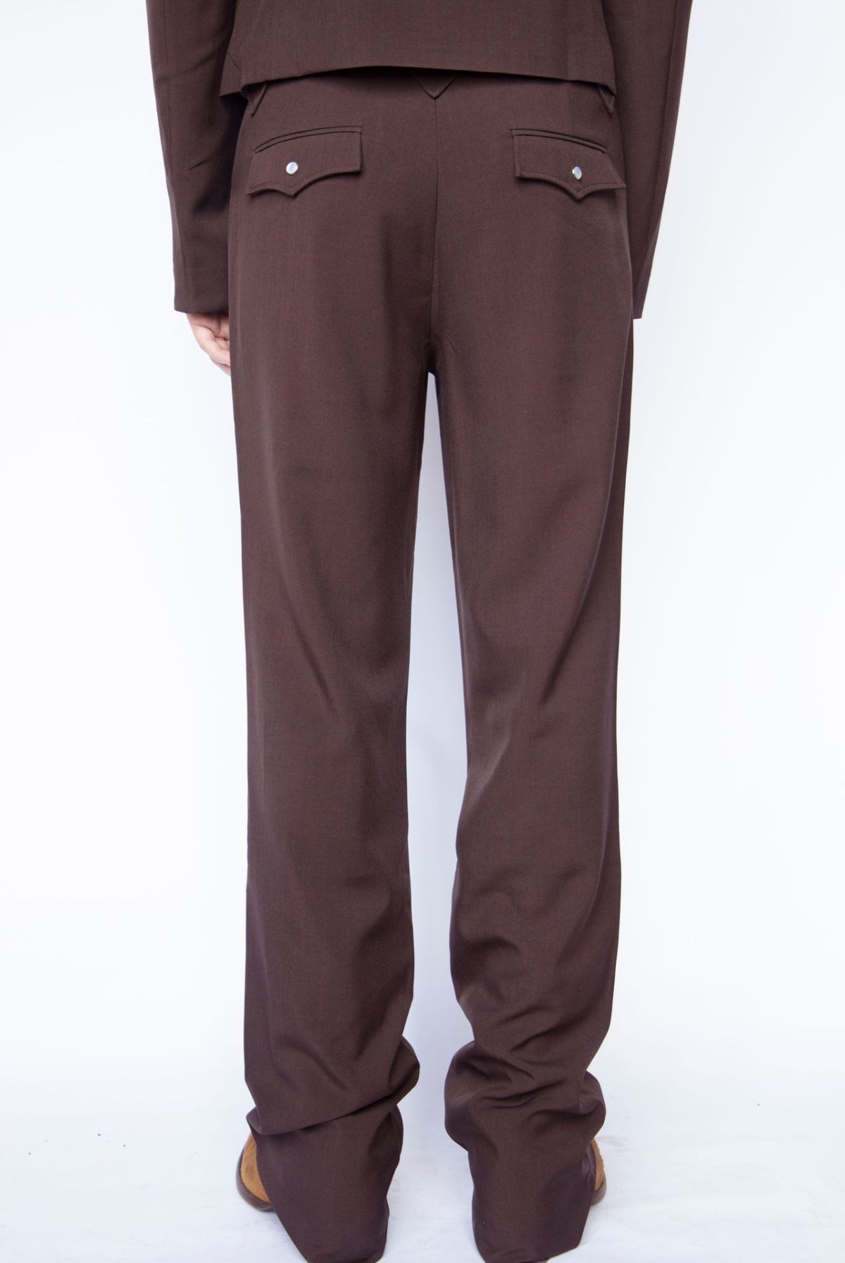 Back of the legs of the H Bar C Franklin chocolate western pants with flap back pockets.