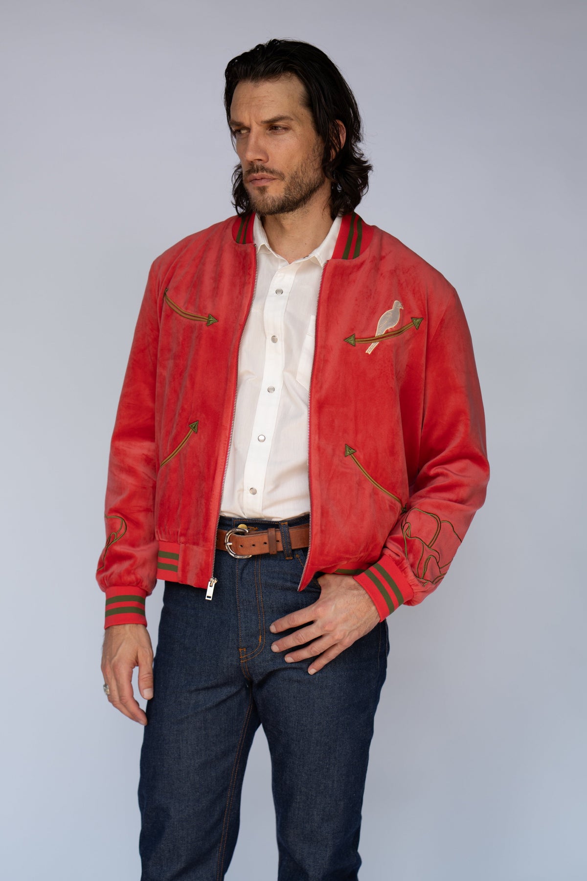 Man in the HBarC x Gibson Dove unisex red velour bomber jacket, a Gibson Guitar collaboration.