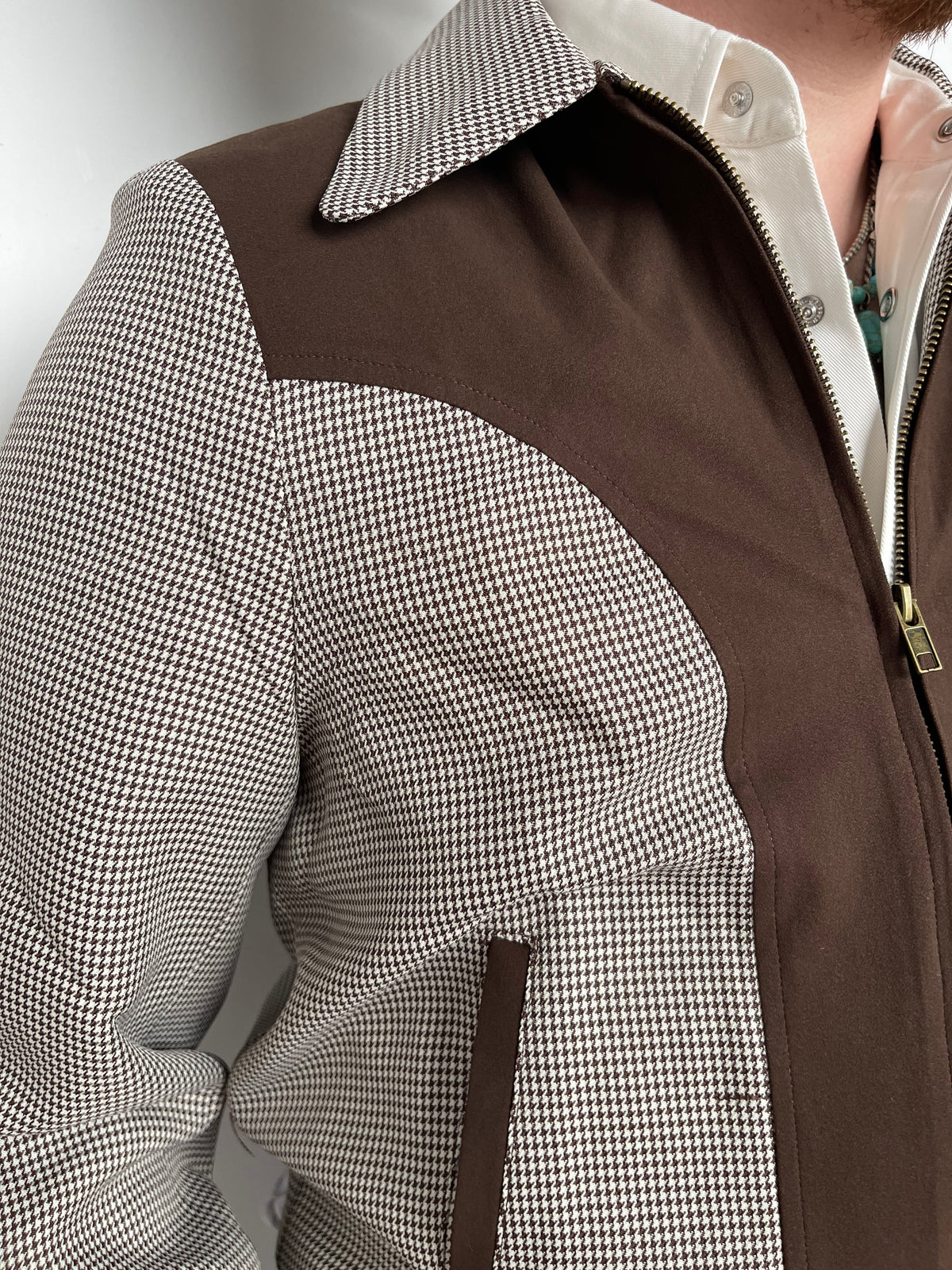 Close-up of the houndstooth fabric and suede yoke seam on the H Bar C Kentucky espresso jacket.