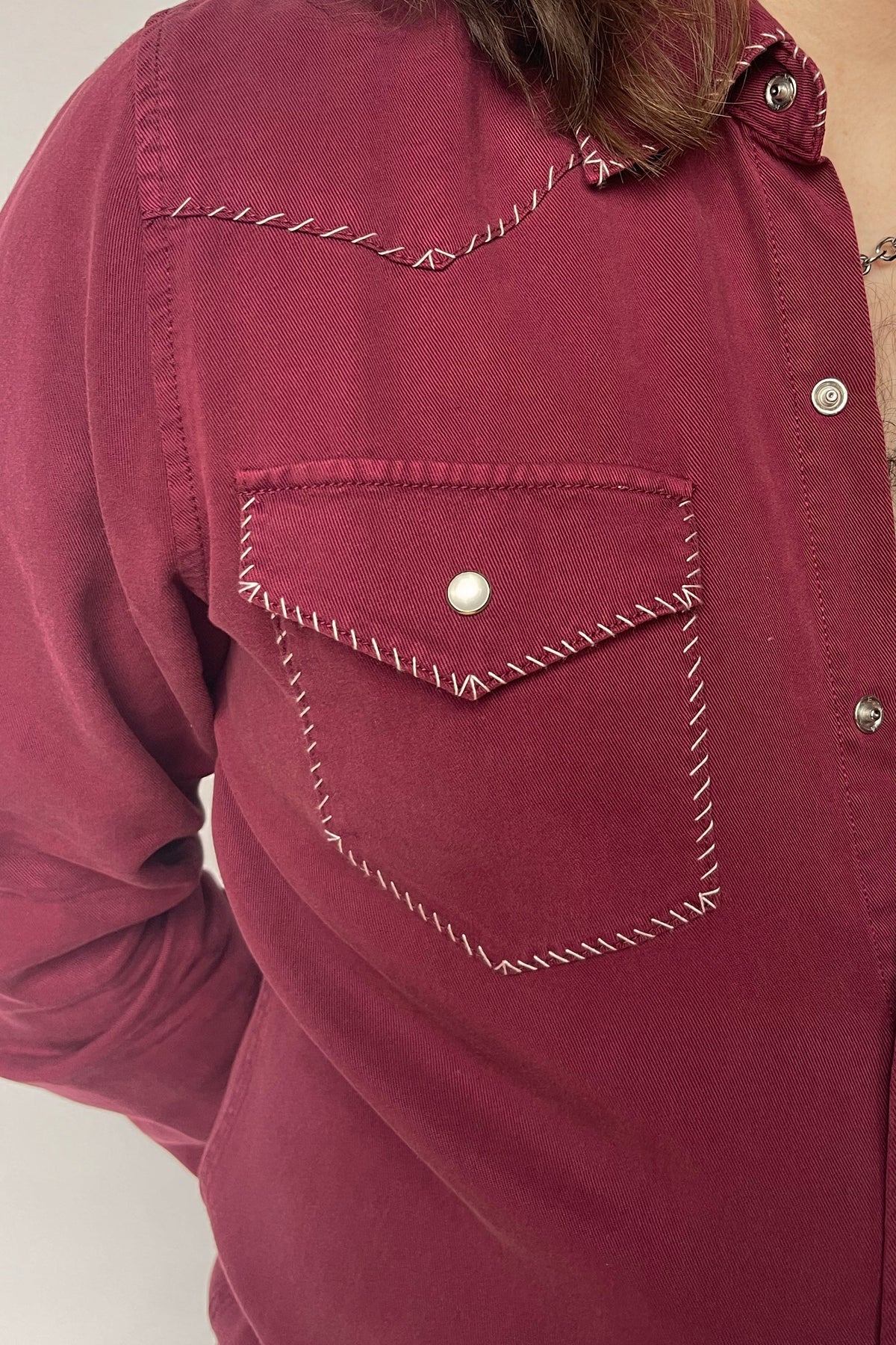 Close-up of the white accent stitched pocket and snap on the H Bar C Brooklyn wine western shirt.