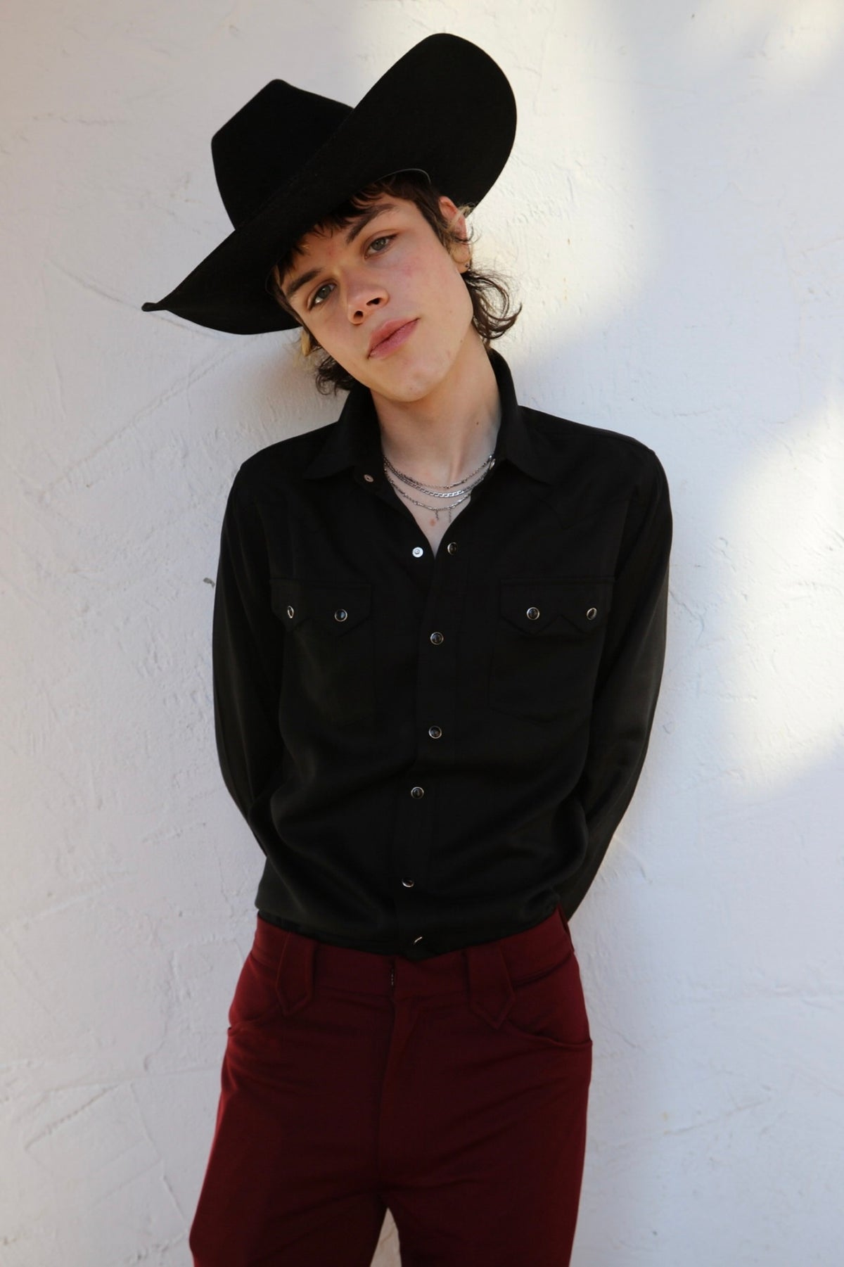 Model in a black cowboy hat wearing the H Bar C Kansas City shirt in black with sawtooth pockets.