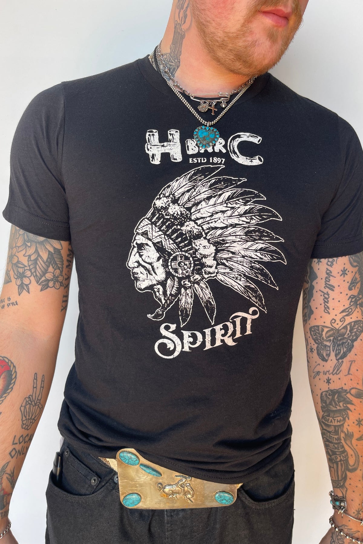 Close-up of the H Bar C Black Spirit graphic tee with chief headdress illustration.