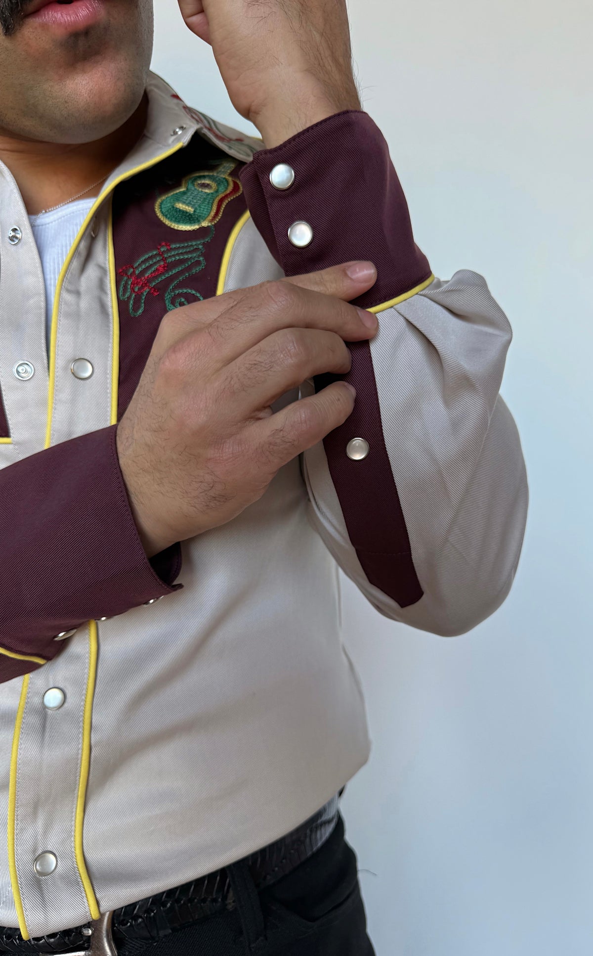 Cuff detail of the H Bar C Cowboy Bob shirt with maroon cuff and pearl snaps.