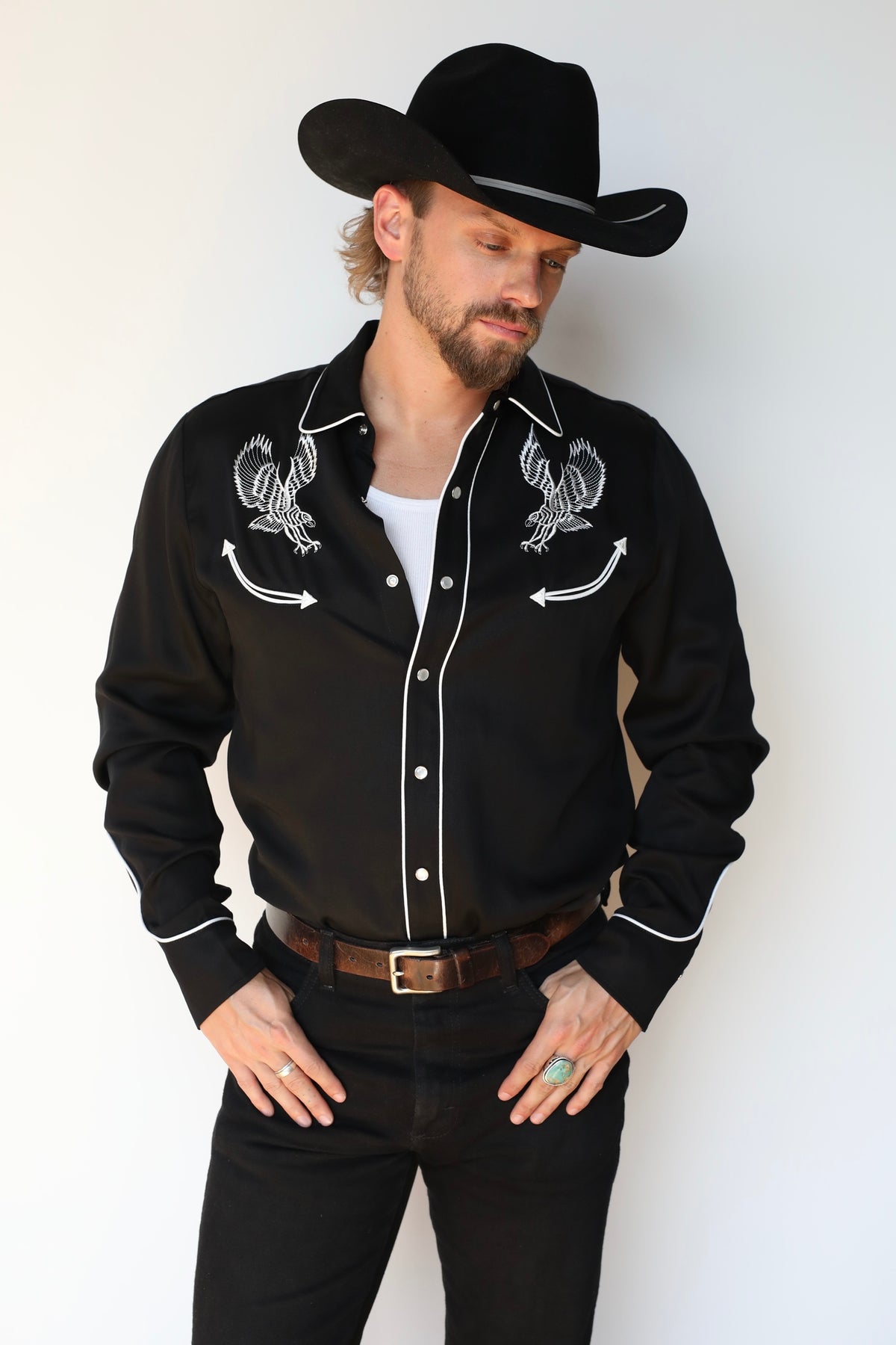 Three-quarter view of the H Bar C Double Eagle black western shirt with embroidered eagles, piping, and smile pockets.