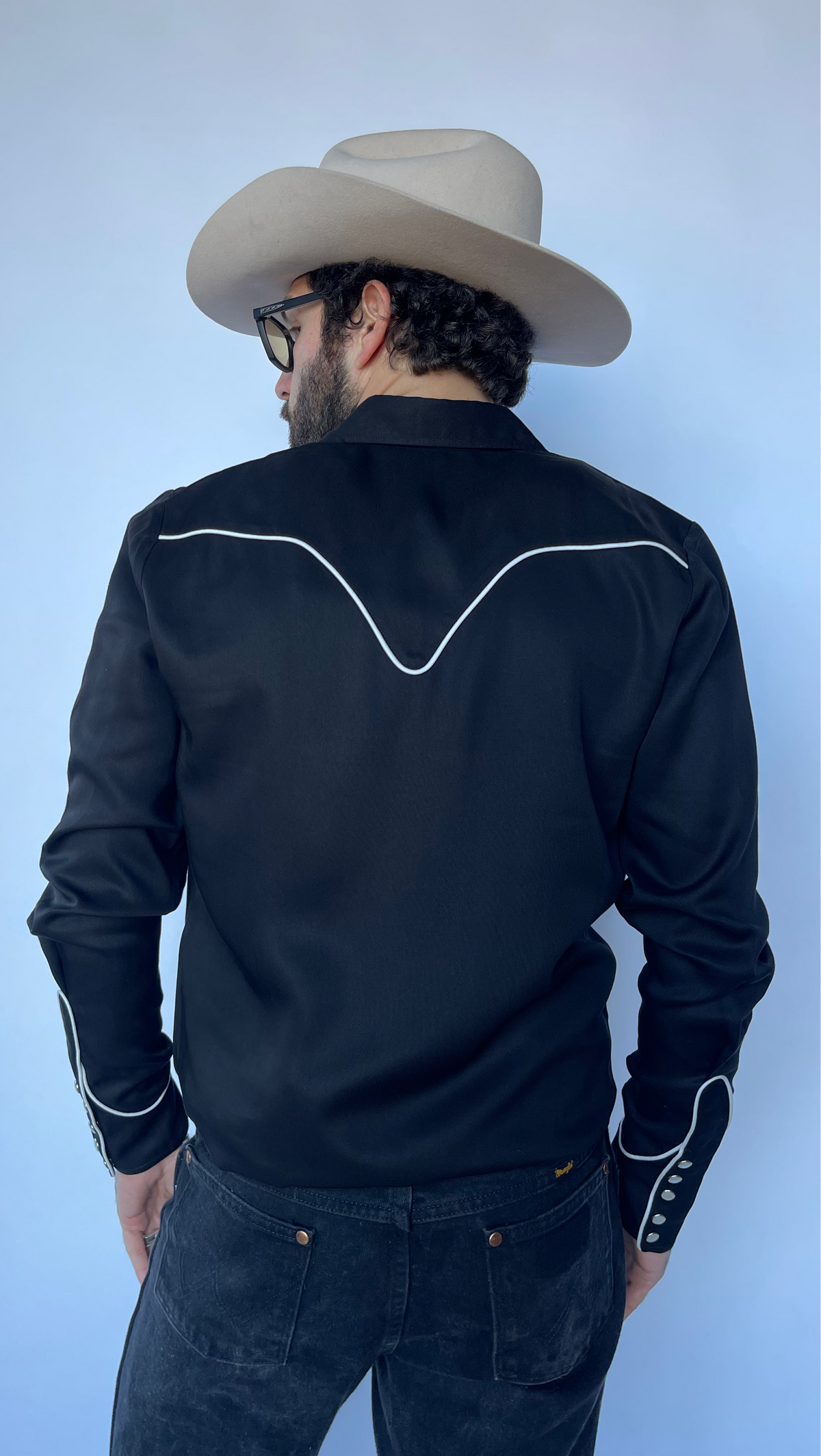 Back view of the H Bar C Nashville black western shirt with white piped back yoke.