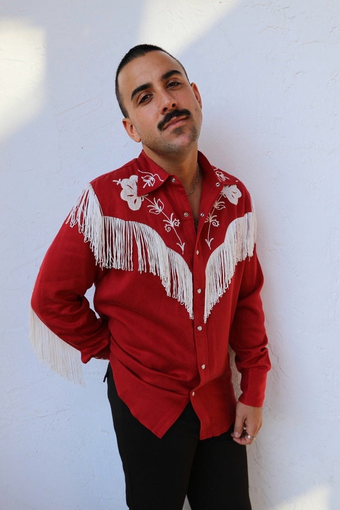 Man wearing the H Bar C Taos men's shirt in red with white fringe and embroidery on the yokes.