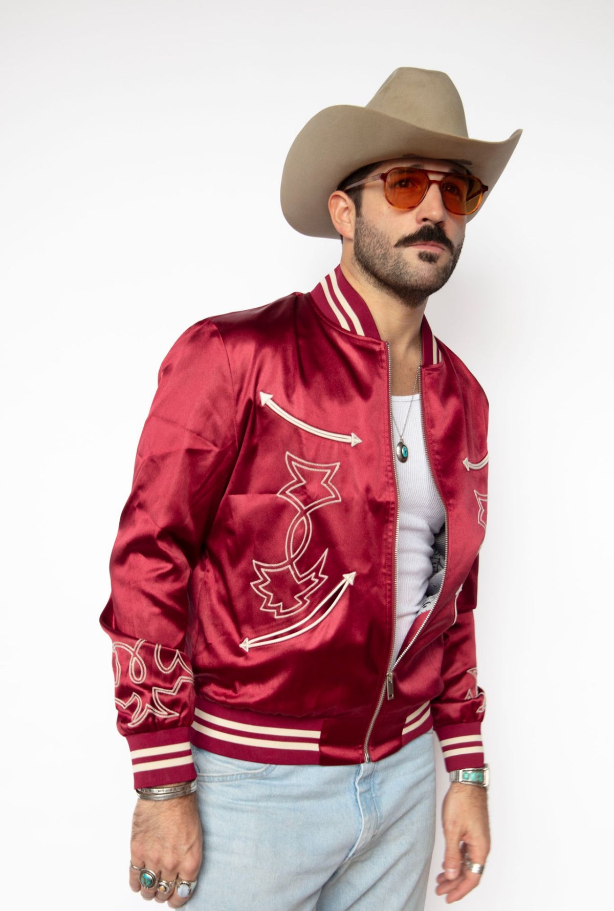 Front view of the H Bar C Odessa red satin jacket with tinted glasses and a cowboy hat.