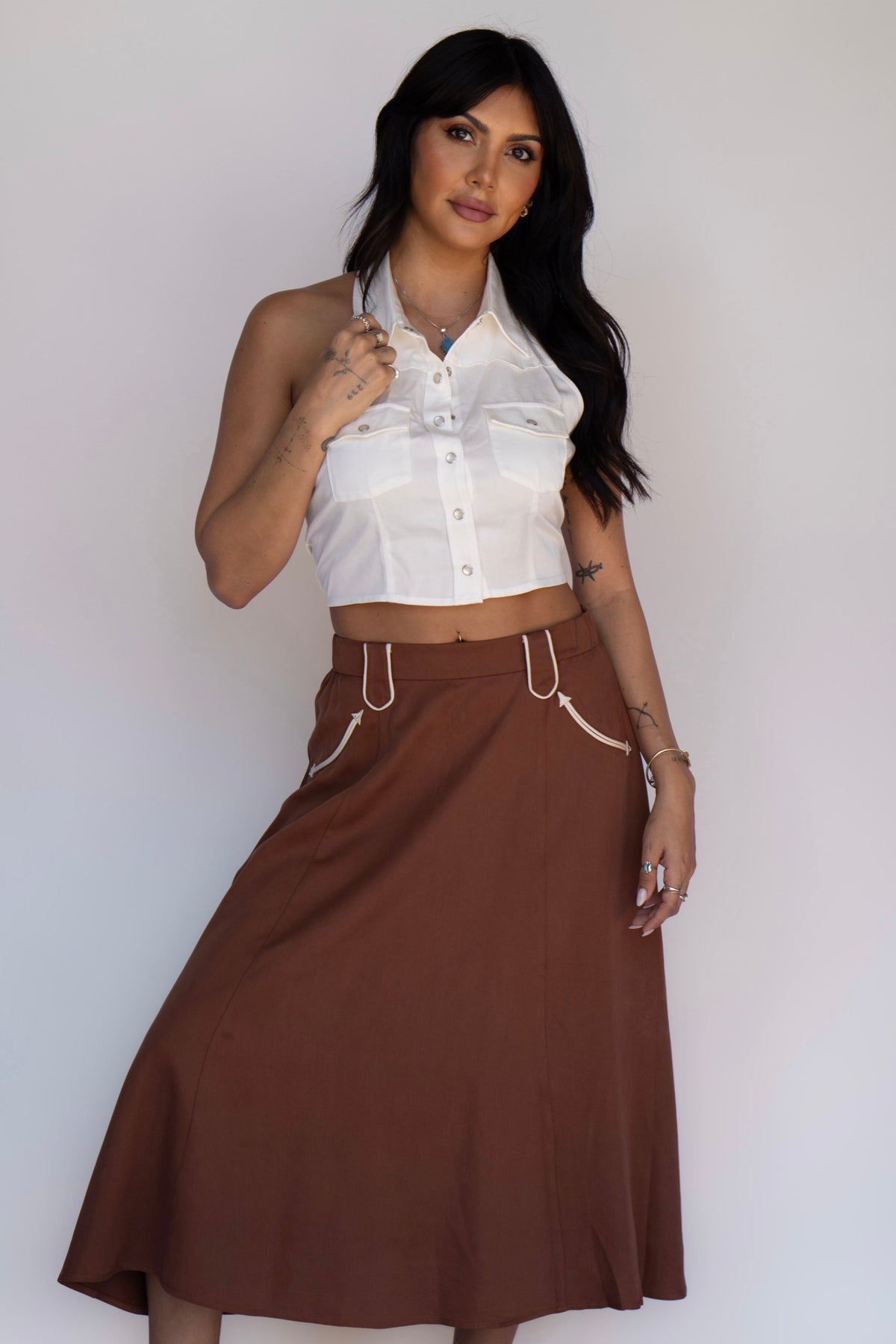 Model in the H Bar C Santa Fe chocolate western skirt and white halter top.