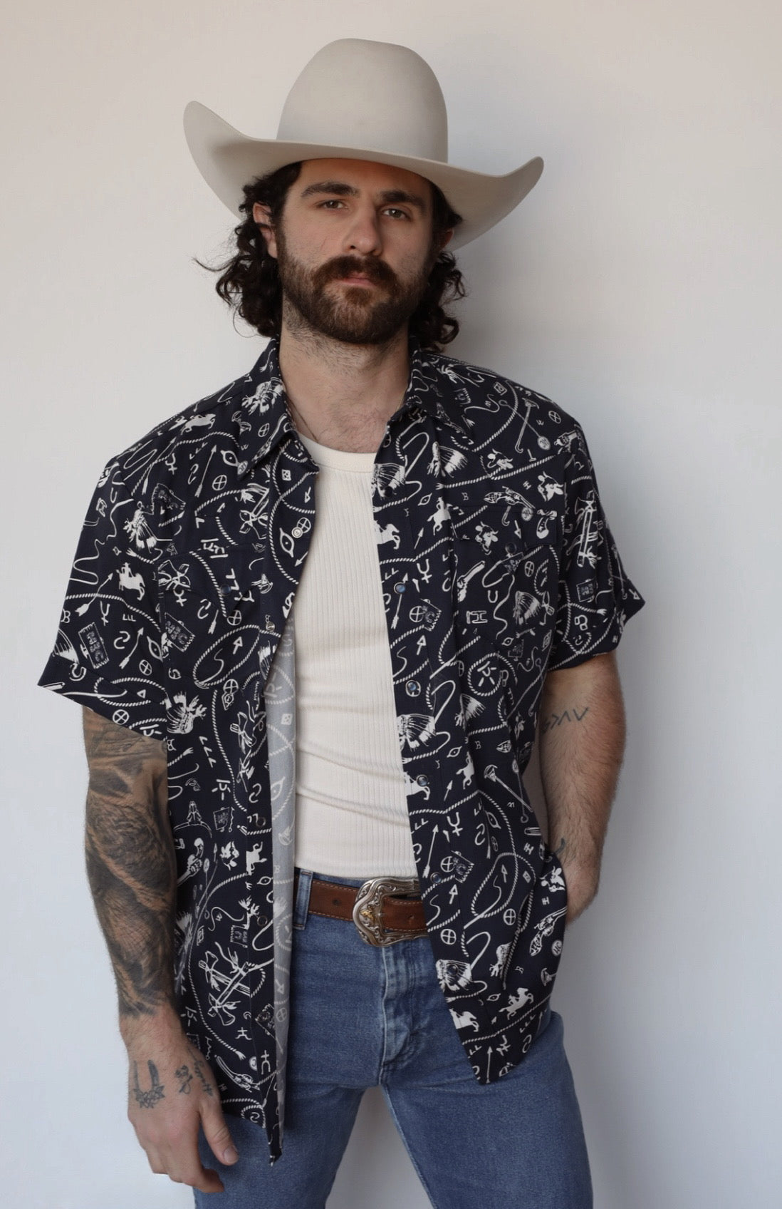 H Bar C Newport Rockridge navy print short sleeve snap shirt worn open over a white tee with jeans.