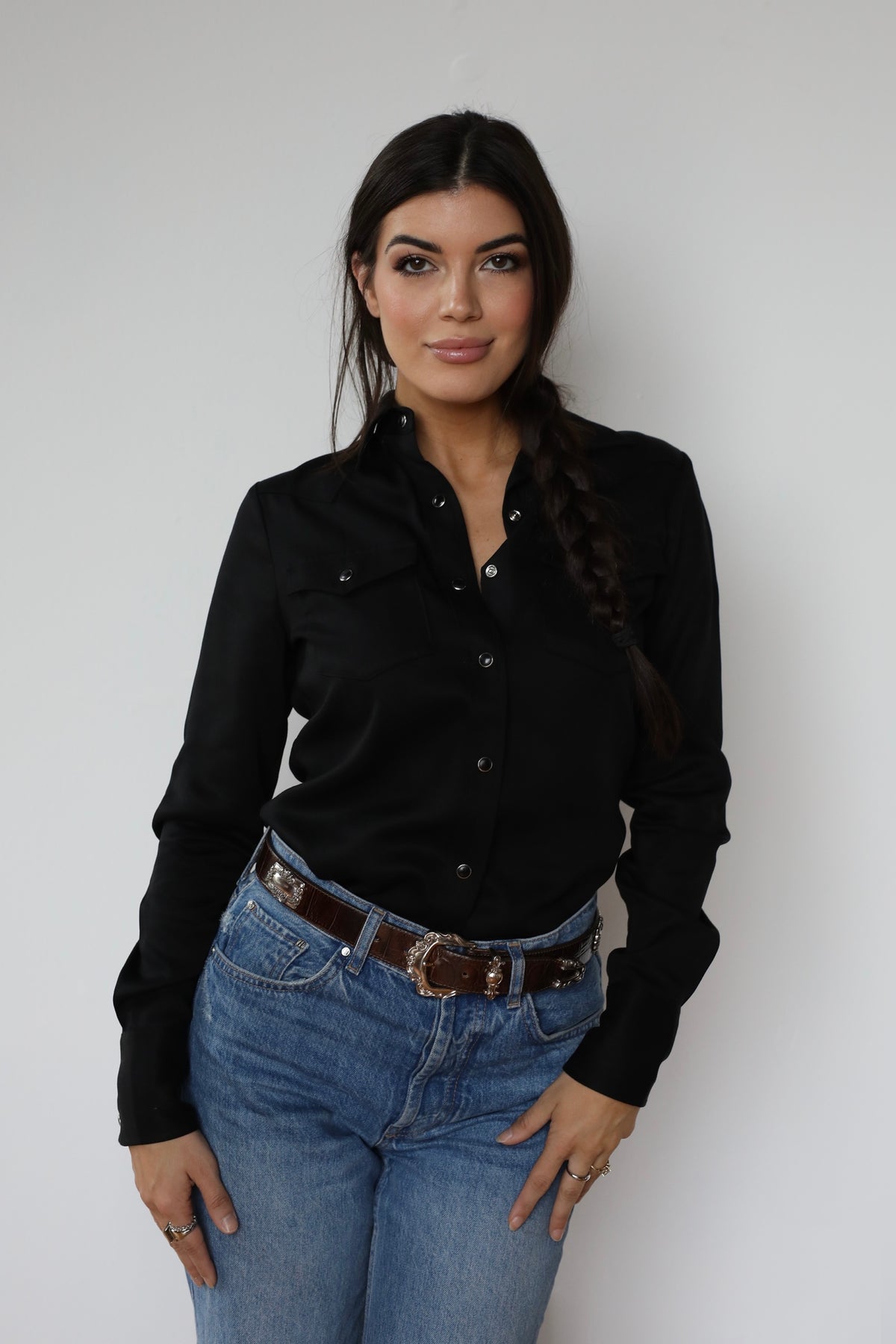 Woman wearing the H Bar C Denver women's shirt in black, a classic Tencel pearl snap western shirt, with jeans.