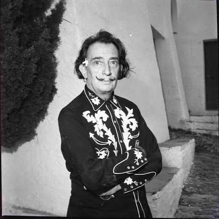 Salvador Dalí posing in an embroidered H Bar C western shirt, archival black and white photograph.