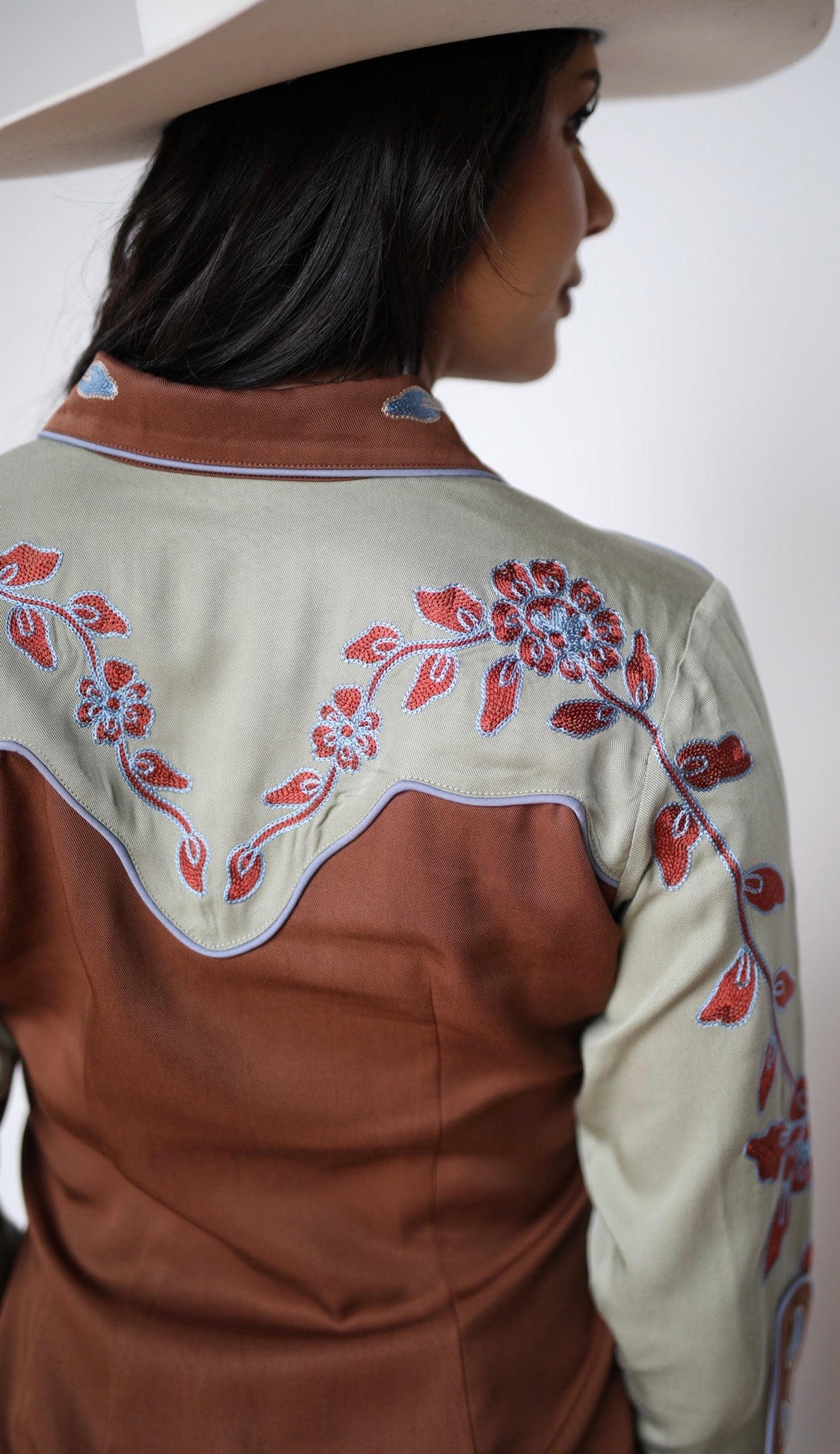 Back yoke of the H Bar C San Antonio women's shirt with sage panel and red floral embroidery.